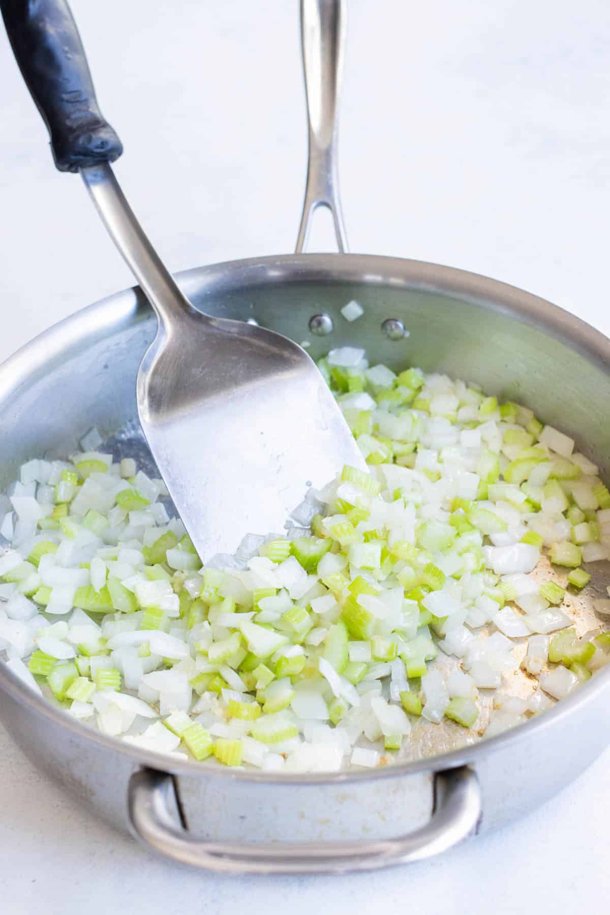 Celery and onions are cooked together.