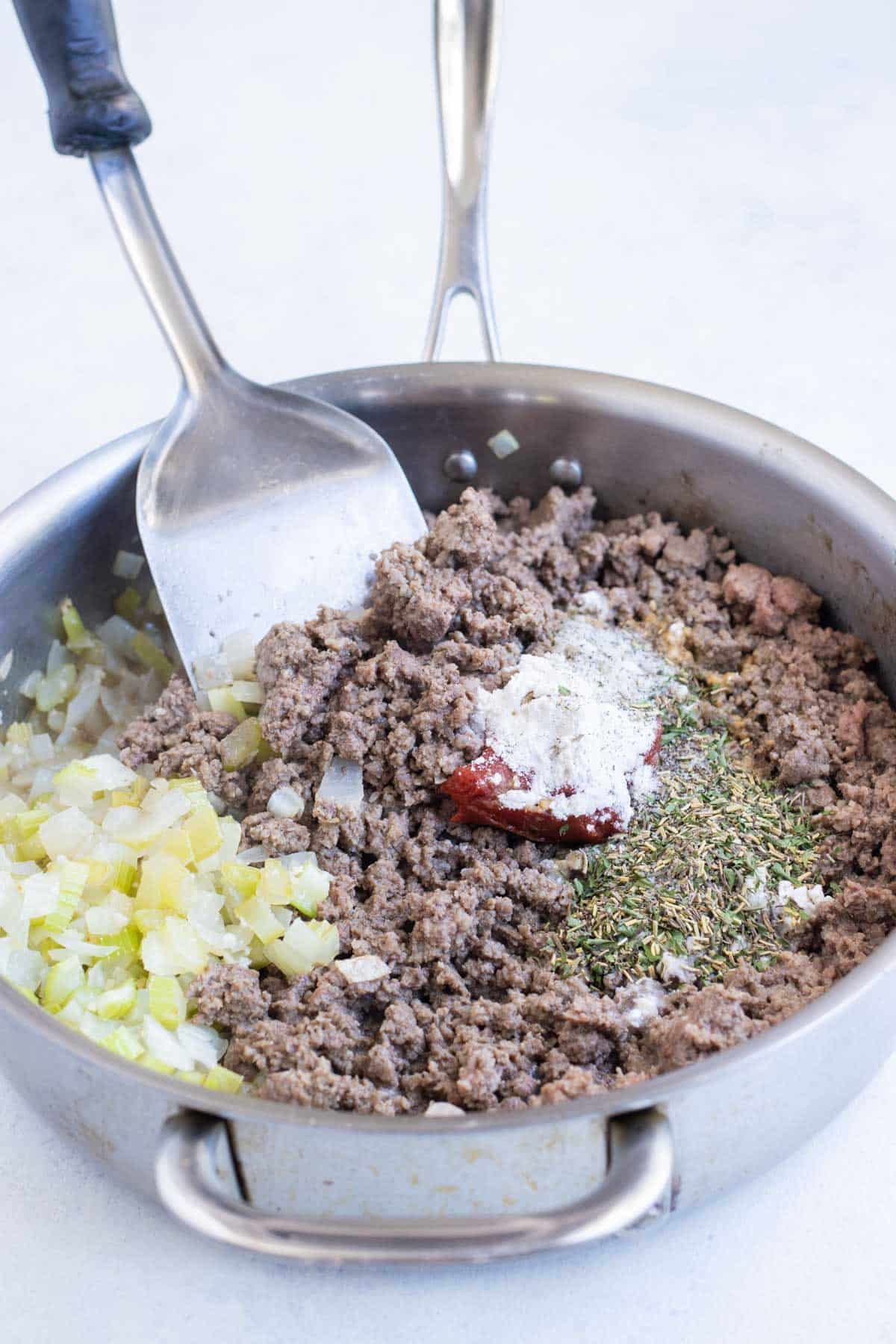 Seasoning is added to ground beef.