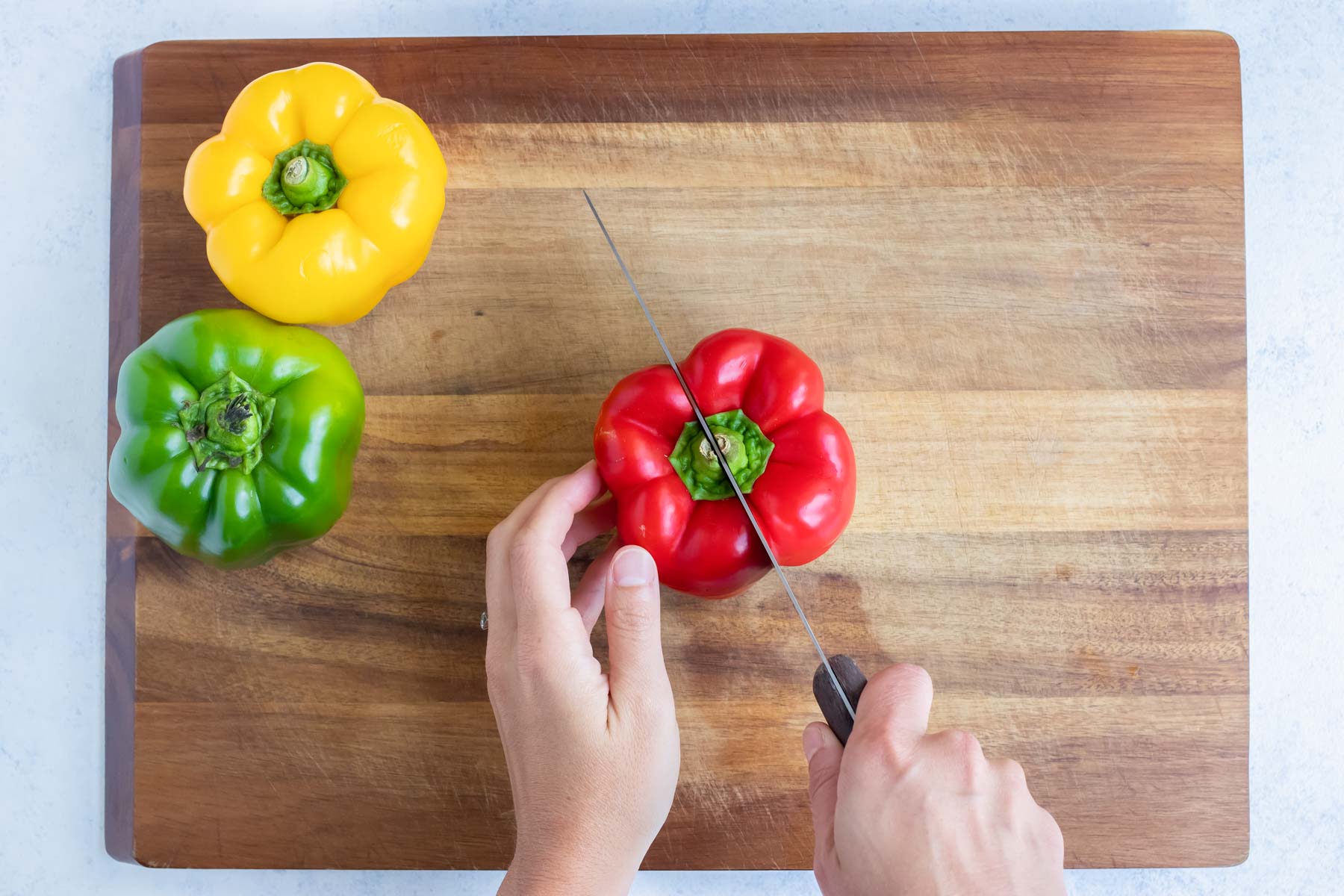 Bell peppers are cut on a cutting board.