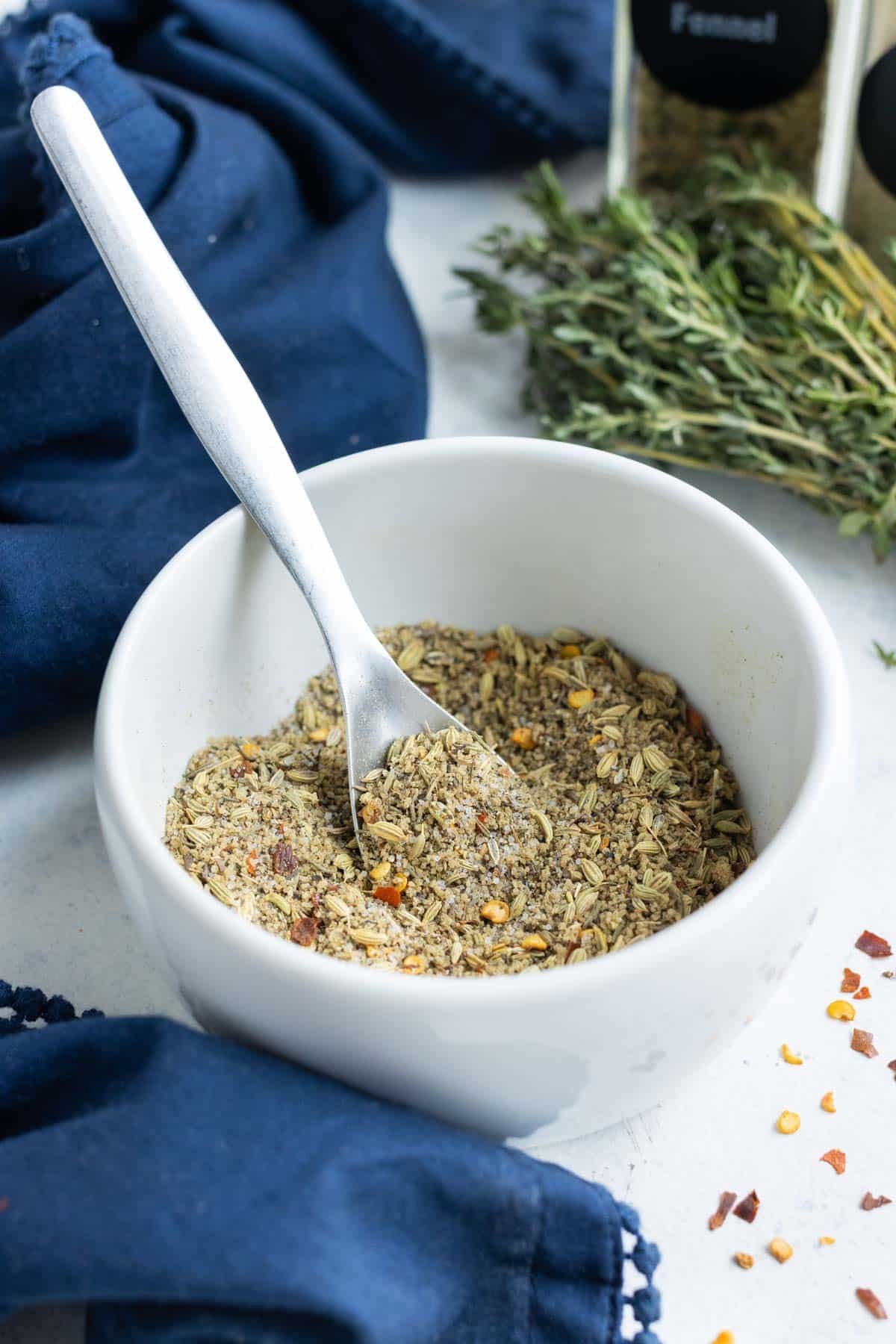 A white bowl full of herbs and spices for breakfast sausage.