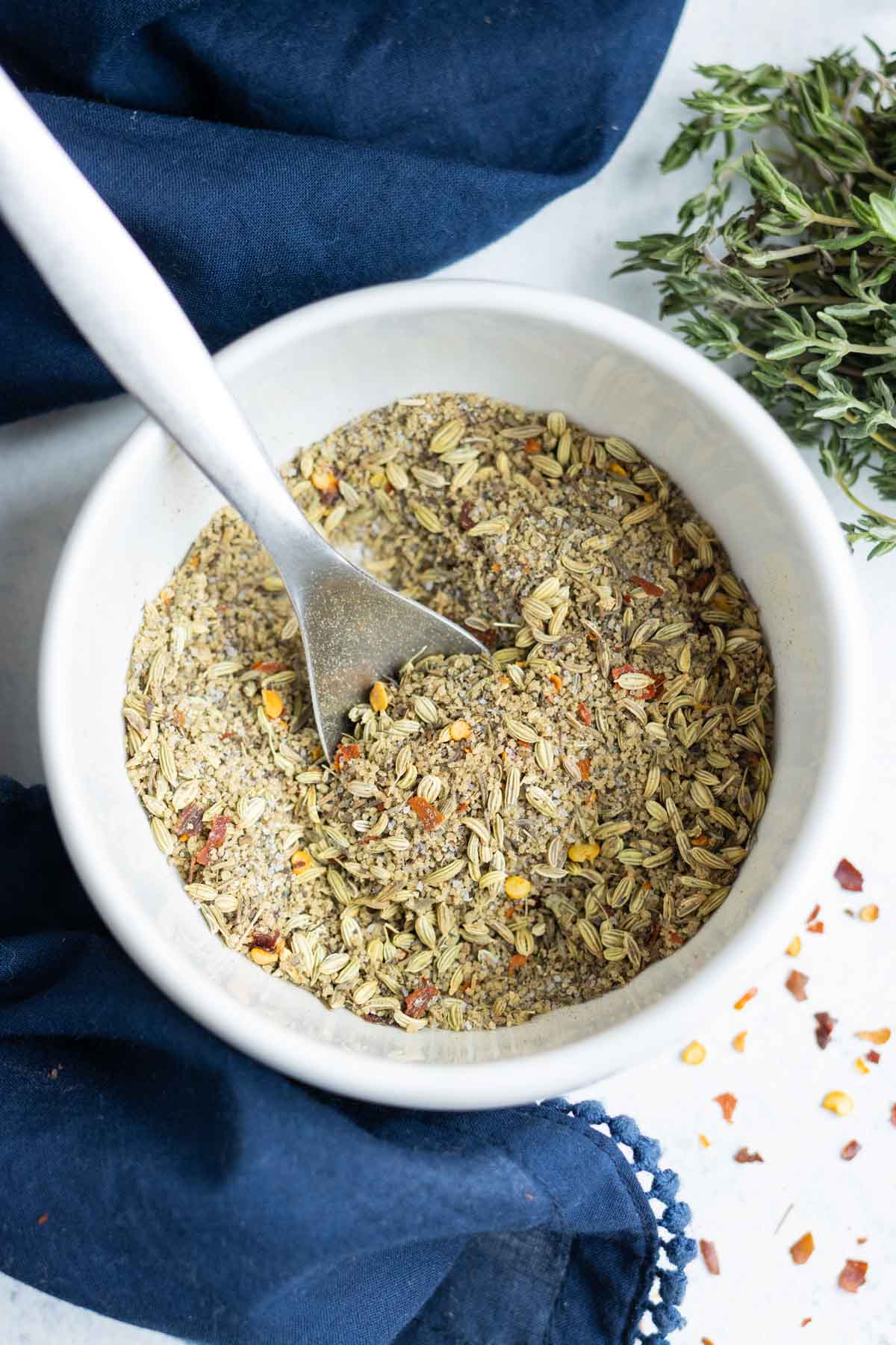 Best Breakfast Sausage Seasoning RECIPE served in a white bowl with a spoon.