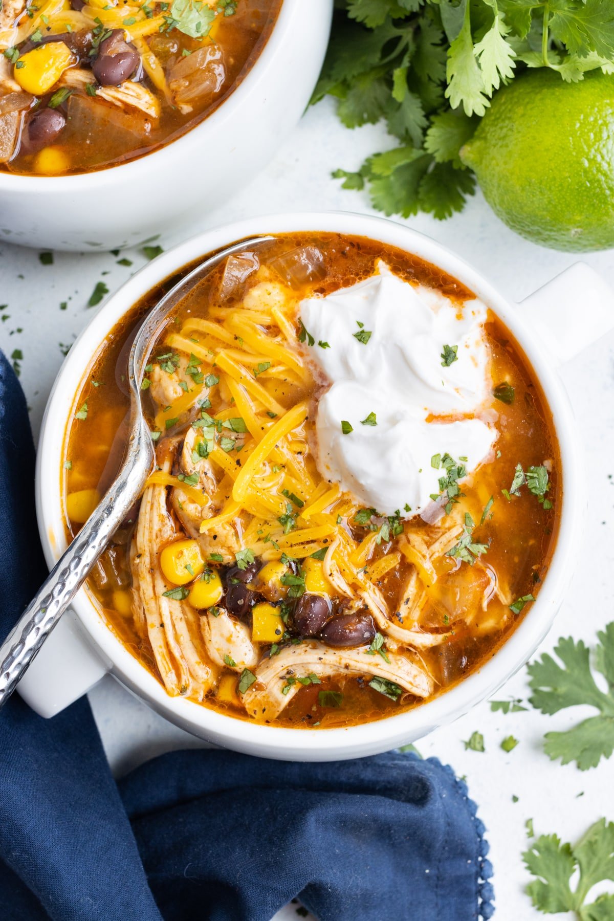 An overhead shot of a bowl with chicken taco soup.