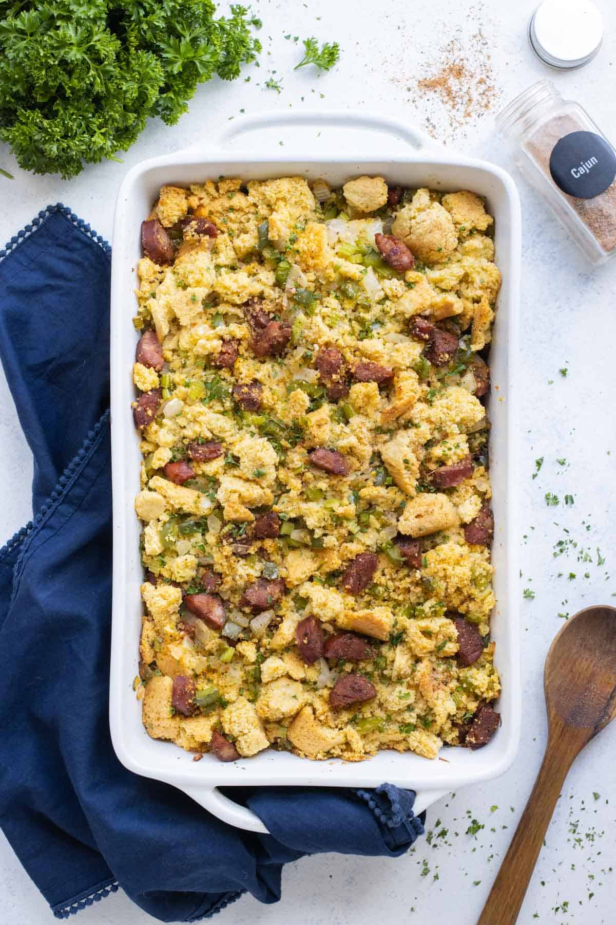 A large baking dish is full of cornbread dressing with sausage.