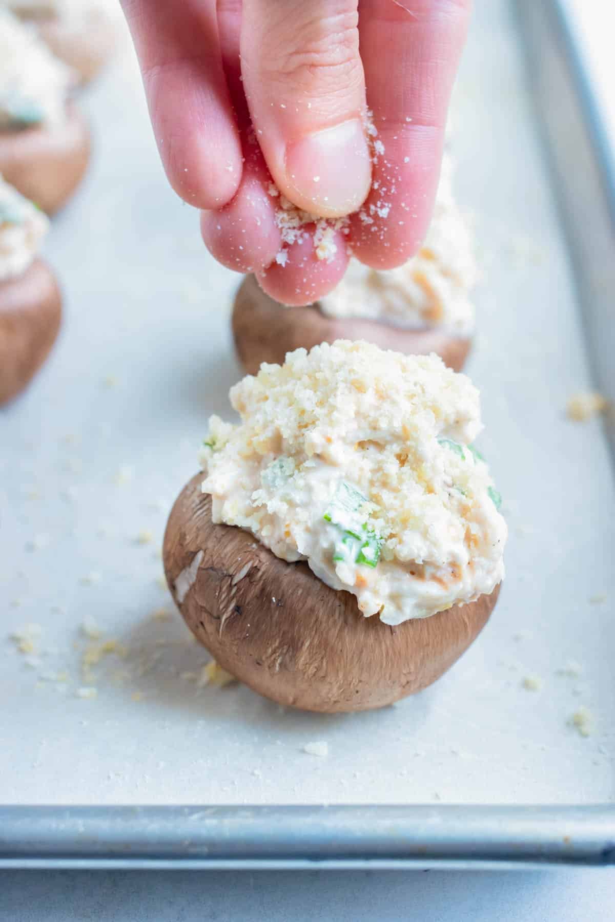 Crab stuffed mushrooms are topped with breadcrumbs and parmesan cheese.