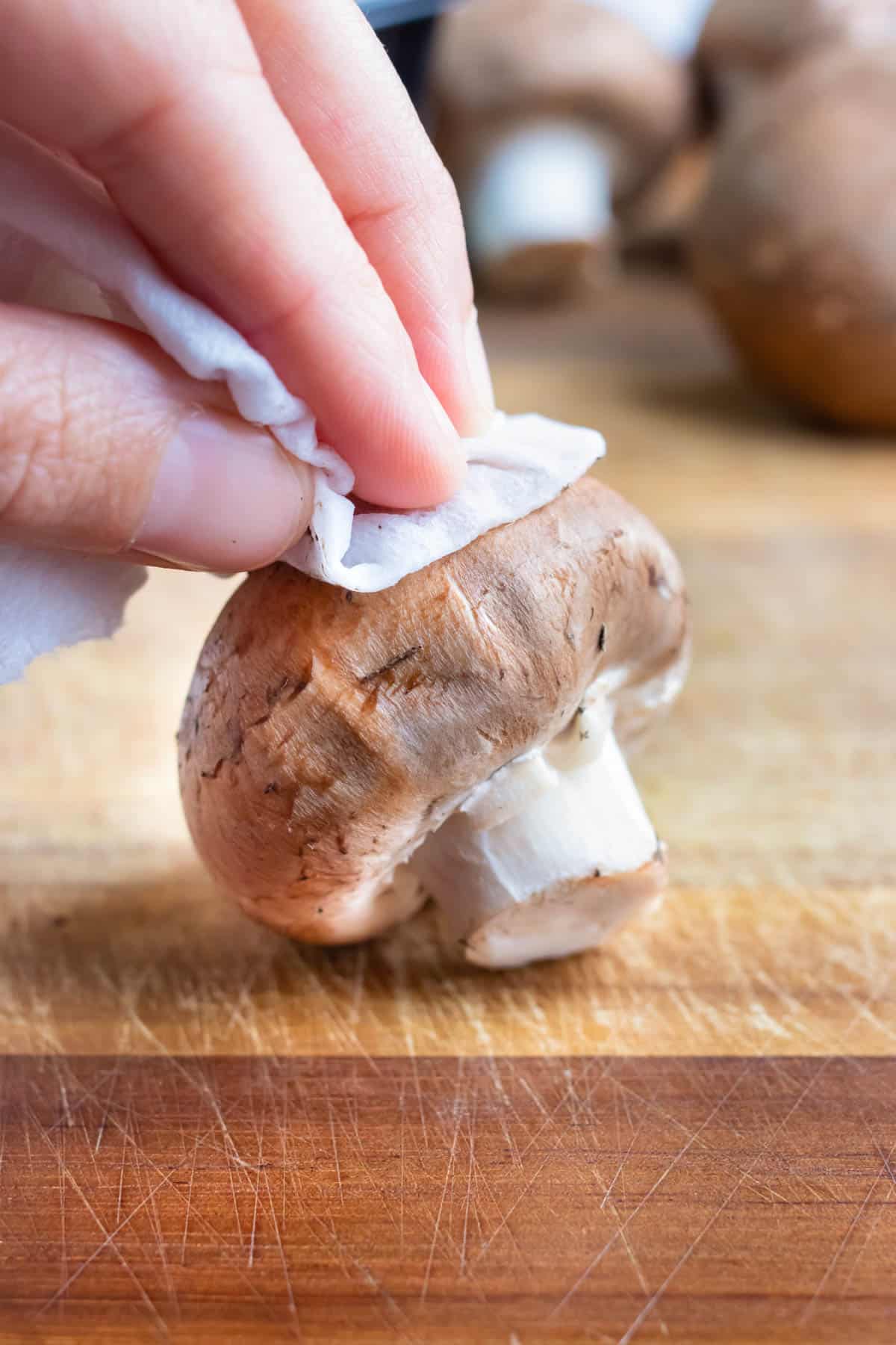 Mushrooms are cleaned with a damp paper towel.