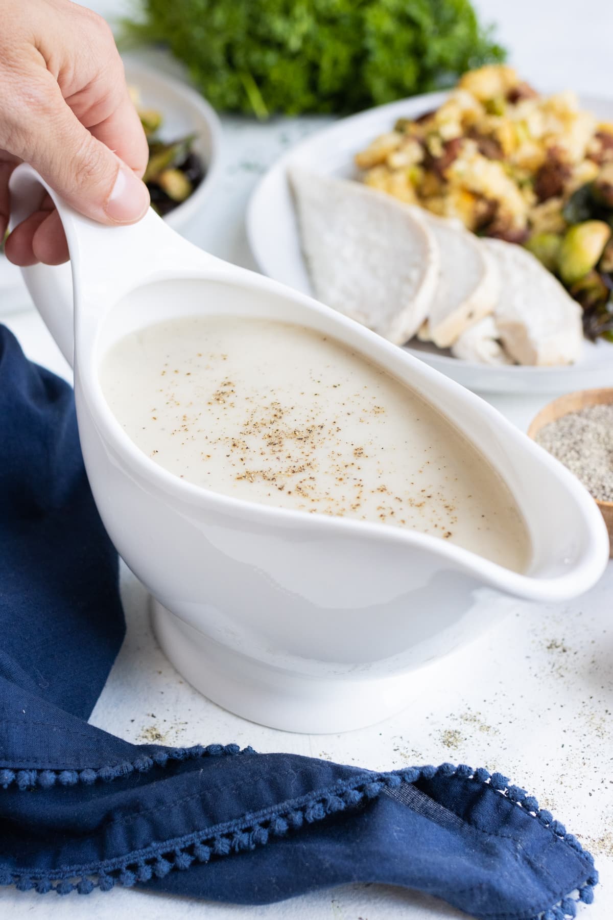 A gravy boat is full of homemade gravy made without drippings.