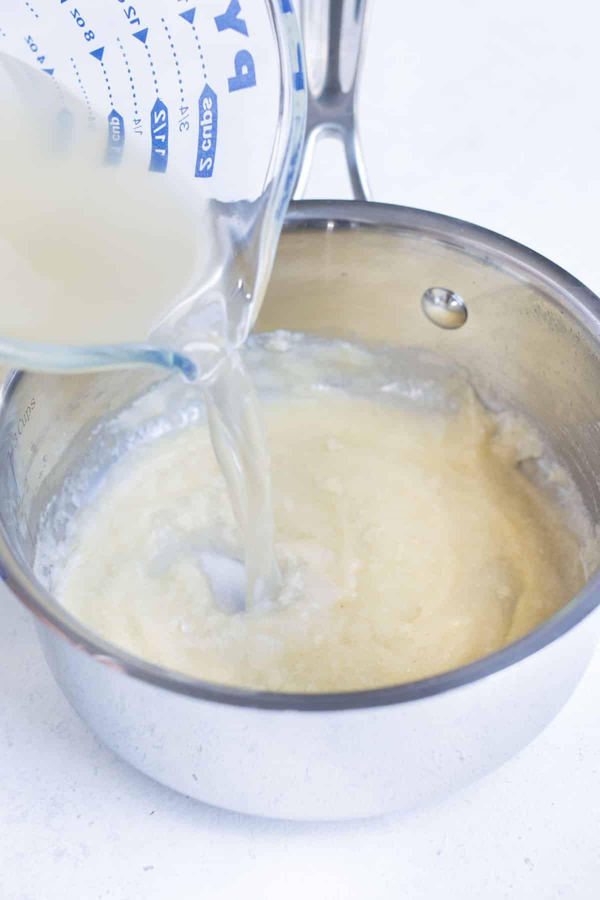 Broth is poured into a roux in batches.