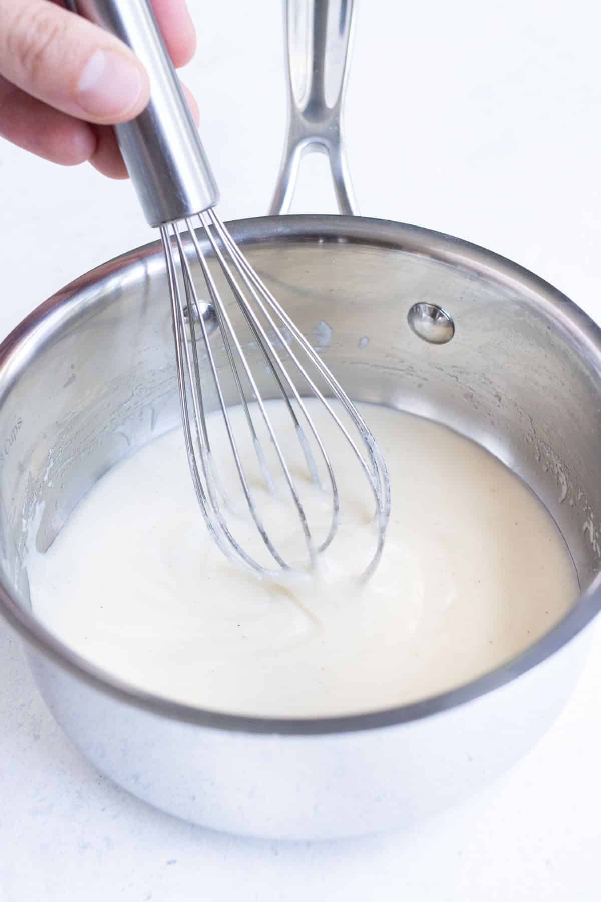 A whisk mixes the roux.