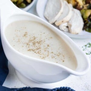 A gravy boat full of gravy is ready to serve.