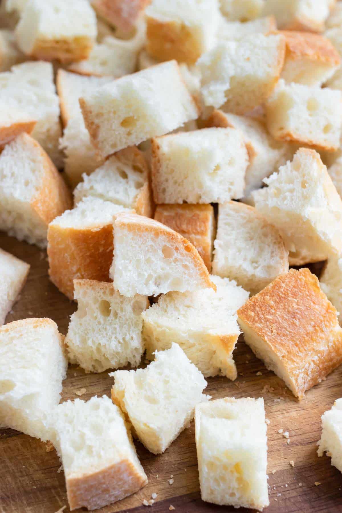 Cubes of bread are prepared for baking.