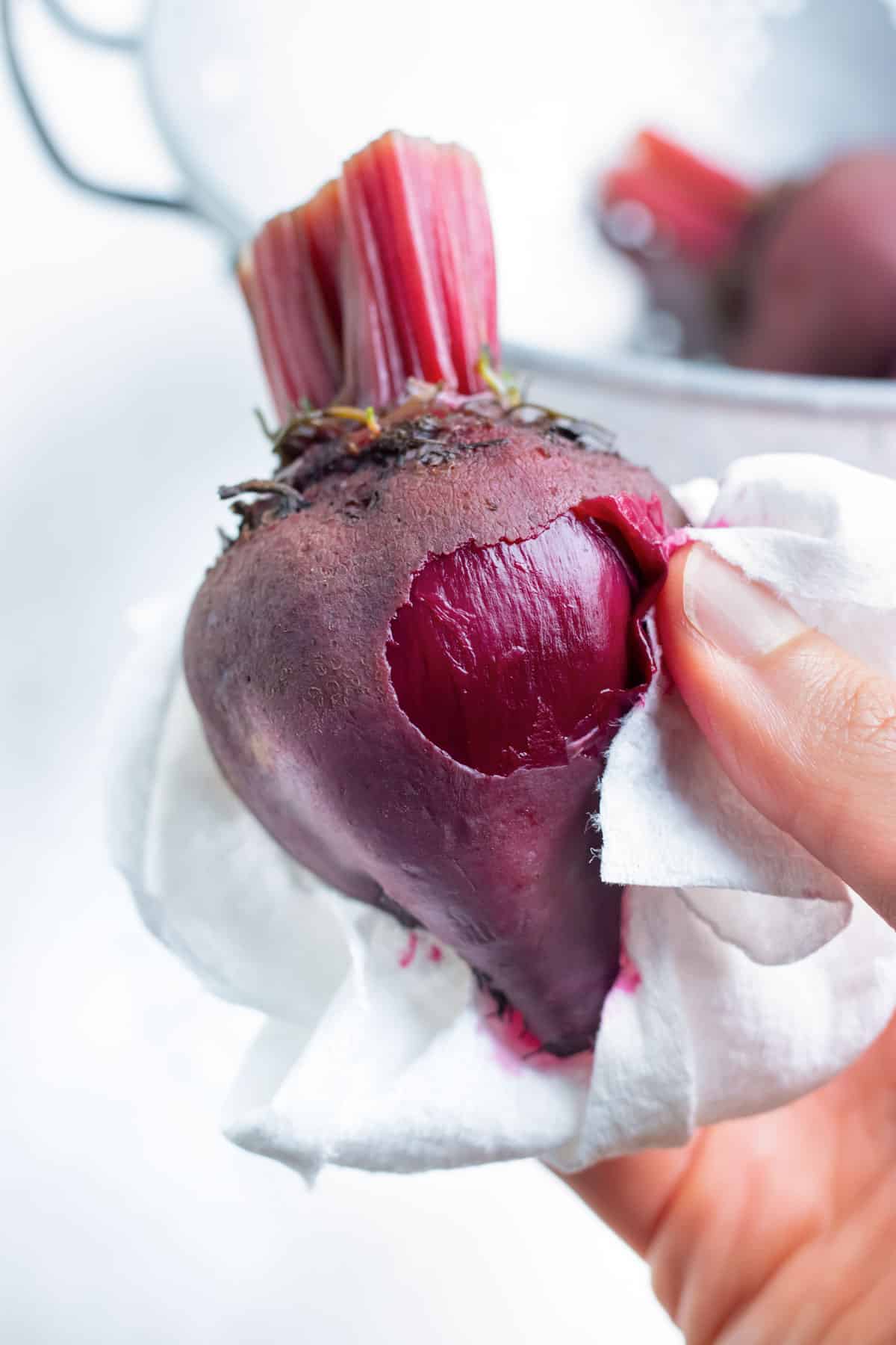 After boiling, outer beet skins are peeled.