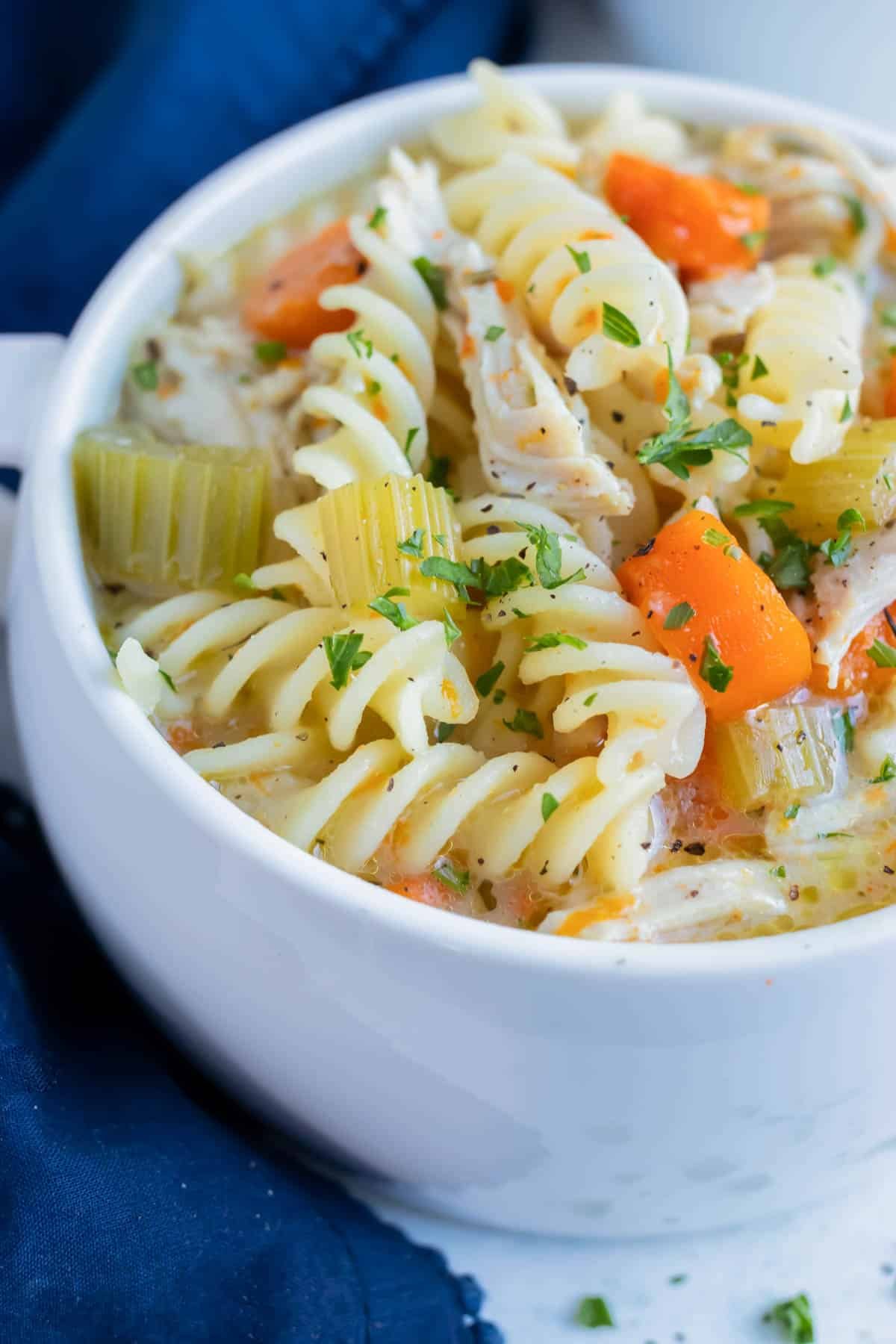 The best instant pot Chicken noodle soup is served in a white bowl.