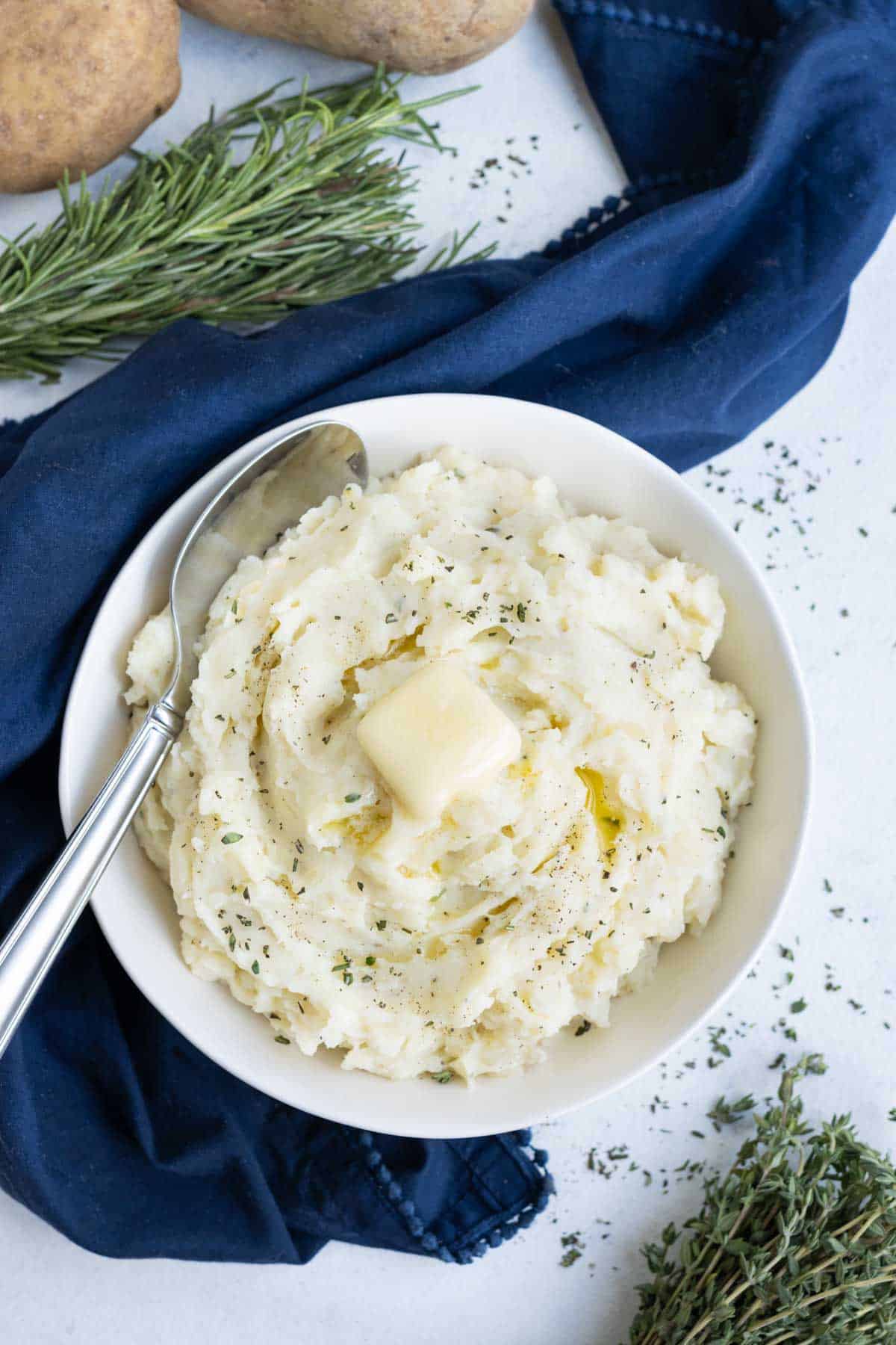 Top mashed potatoes with fresh butter and herbs.