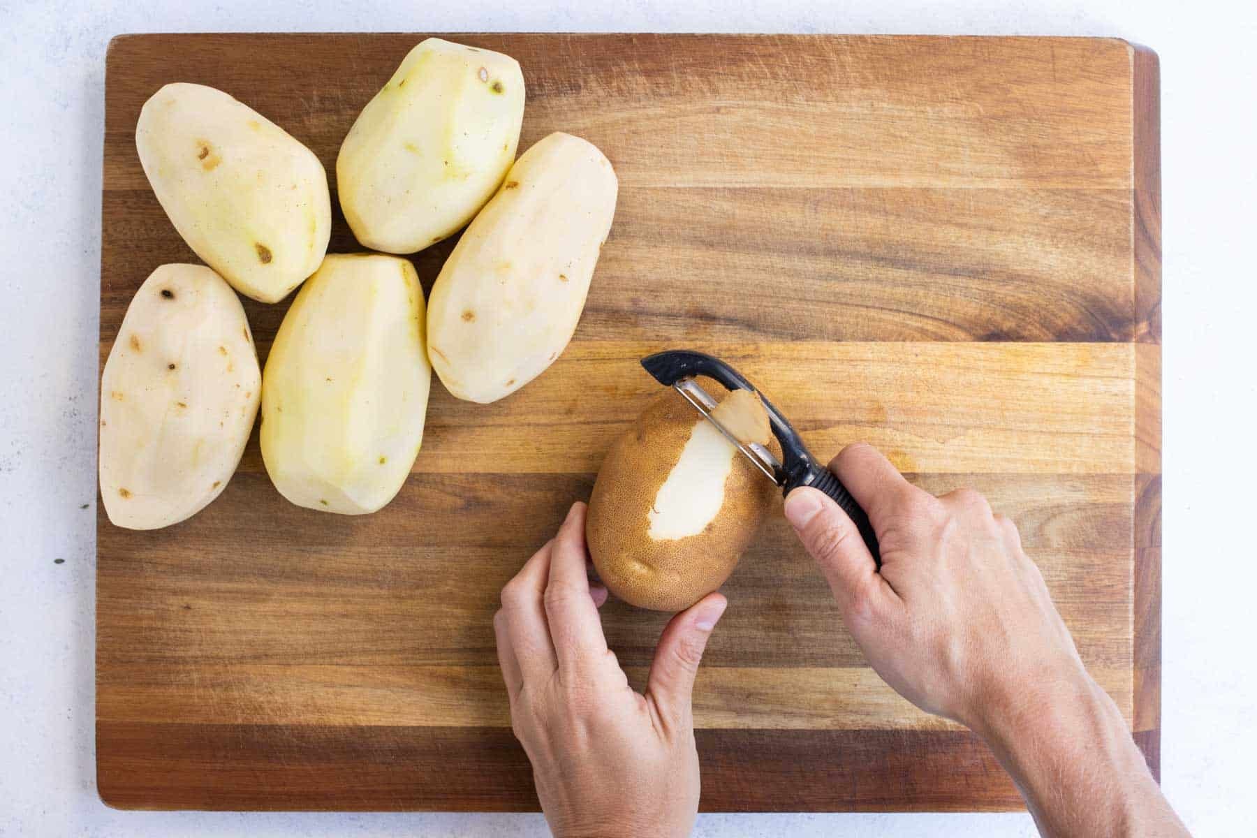 A vegetable peeler removes the skin from potatoes.