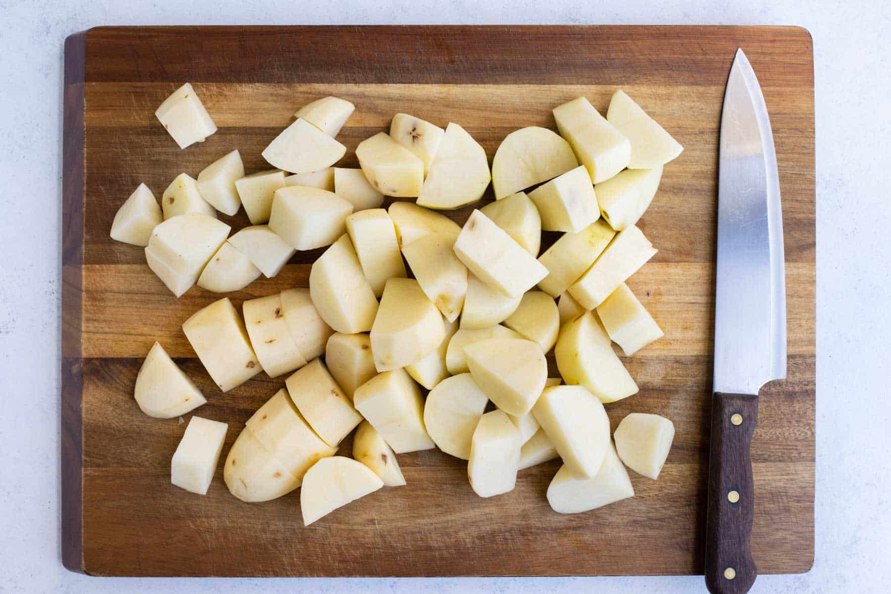 Potatoes are chopped into 1-inch cubes.