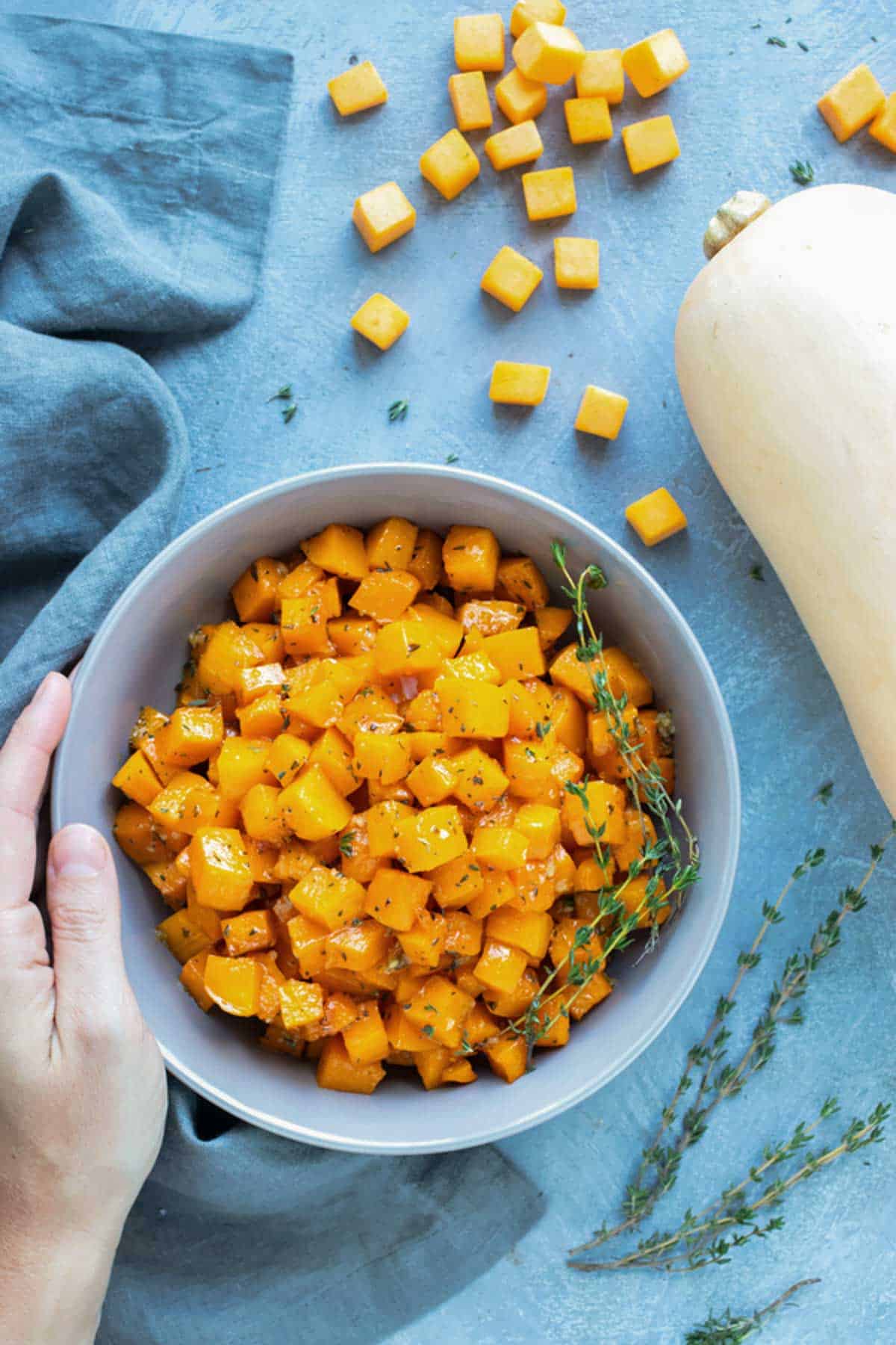 A serving bowl full of butternut squash that has been baked in the oven for a healthy Thanksgiving side dish recipe.