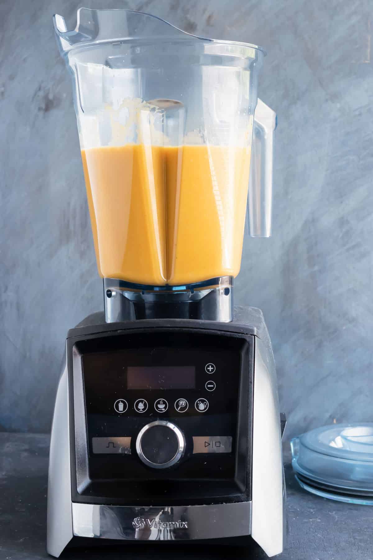 Butternut squash soup being blended until creamy in a Vitamix high-speed blender.