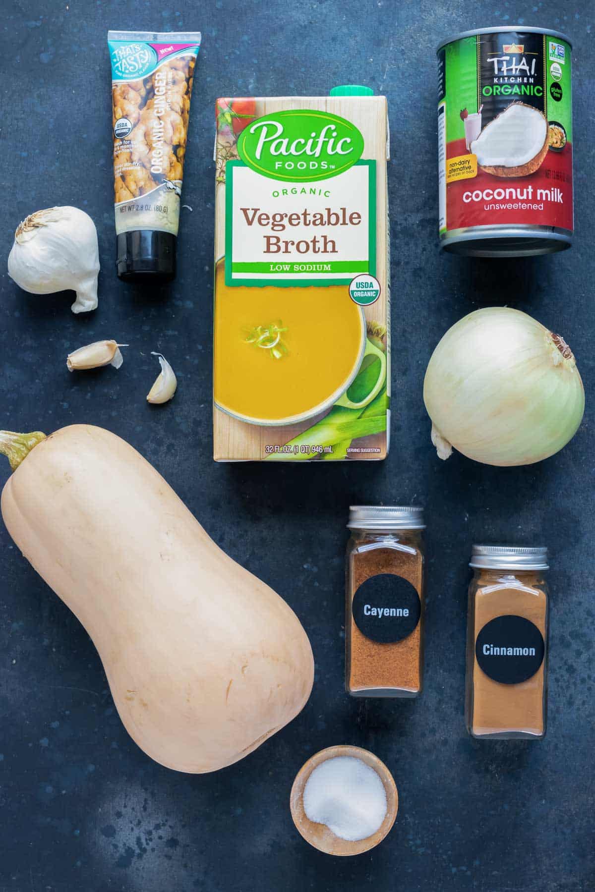 Butternut squash, coconut milk, onion, ginger, garlic, vegetable broth, and spices as the ingredients for a roasted butternut squash soup recipe.