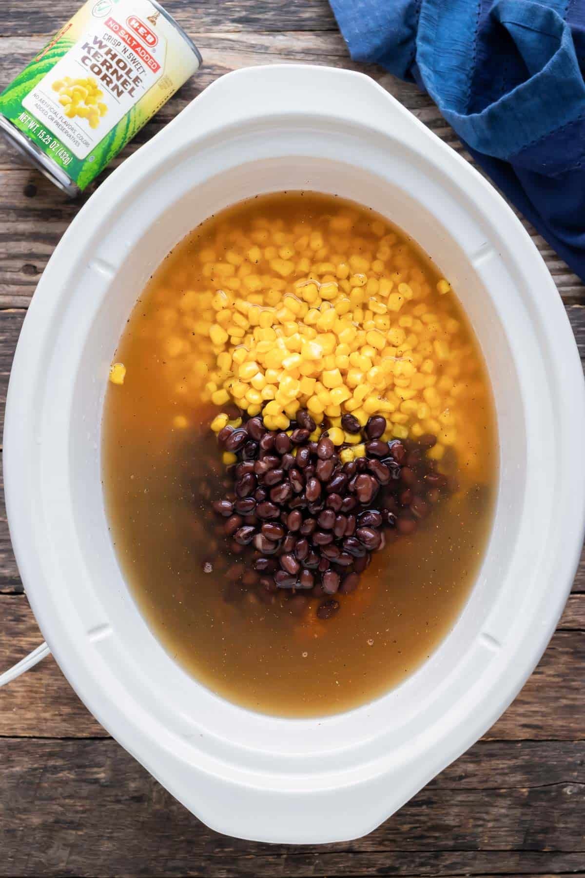 Corn and beans are aded to the soup mixture.