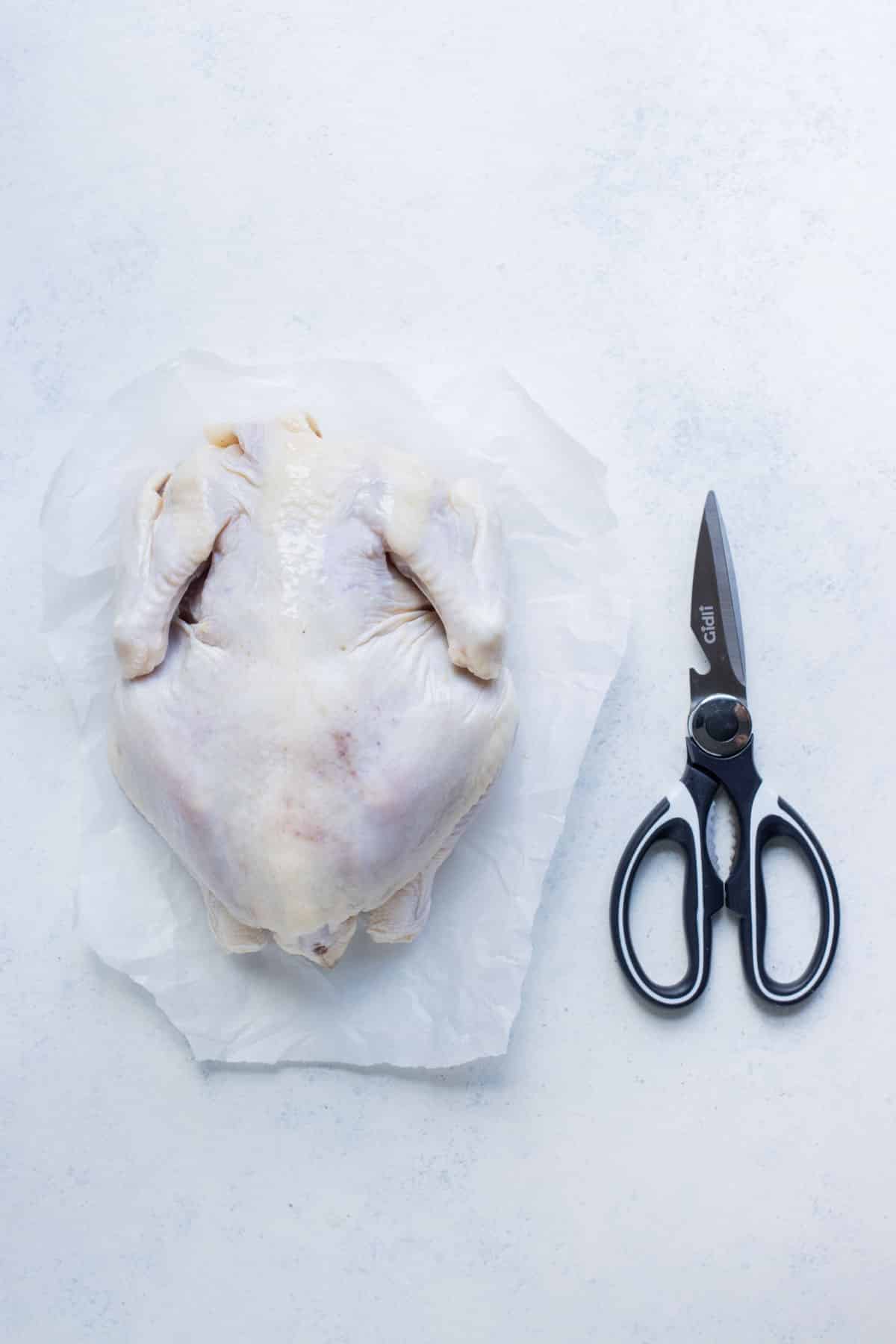 A whole chicken and shears are all you need to spatchcock a chicken.
