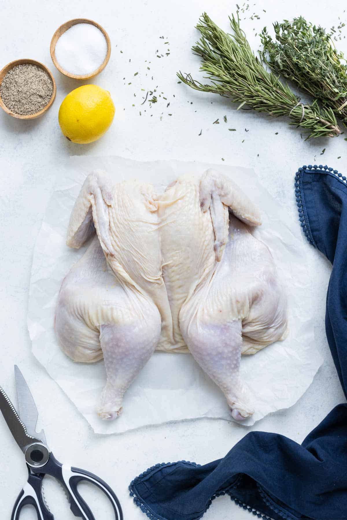 A spatchcock chicken is ready to season and bake.