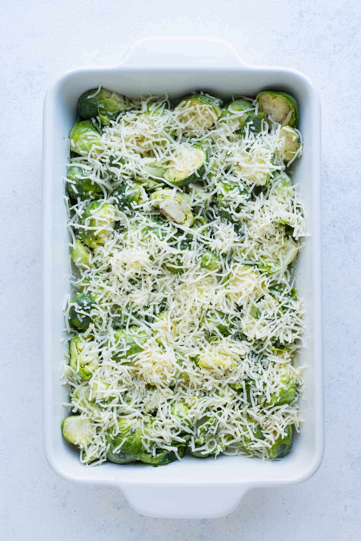 Brussels sprouts are topped with Gruyere cheese.