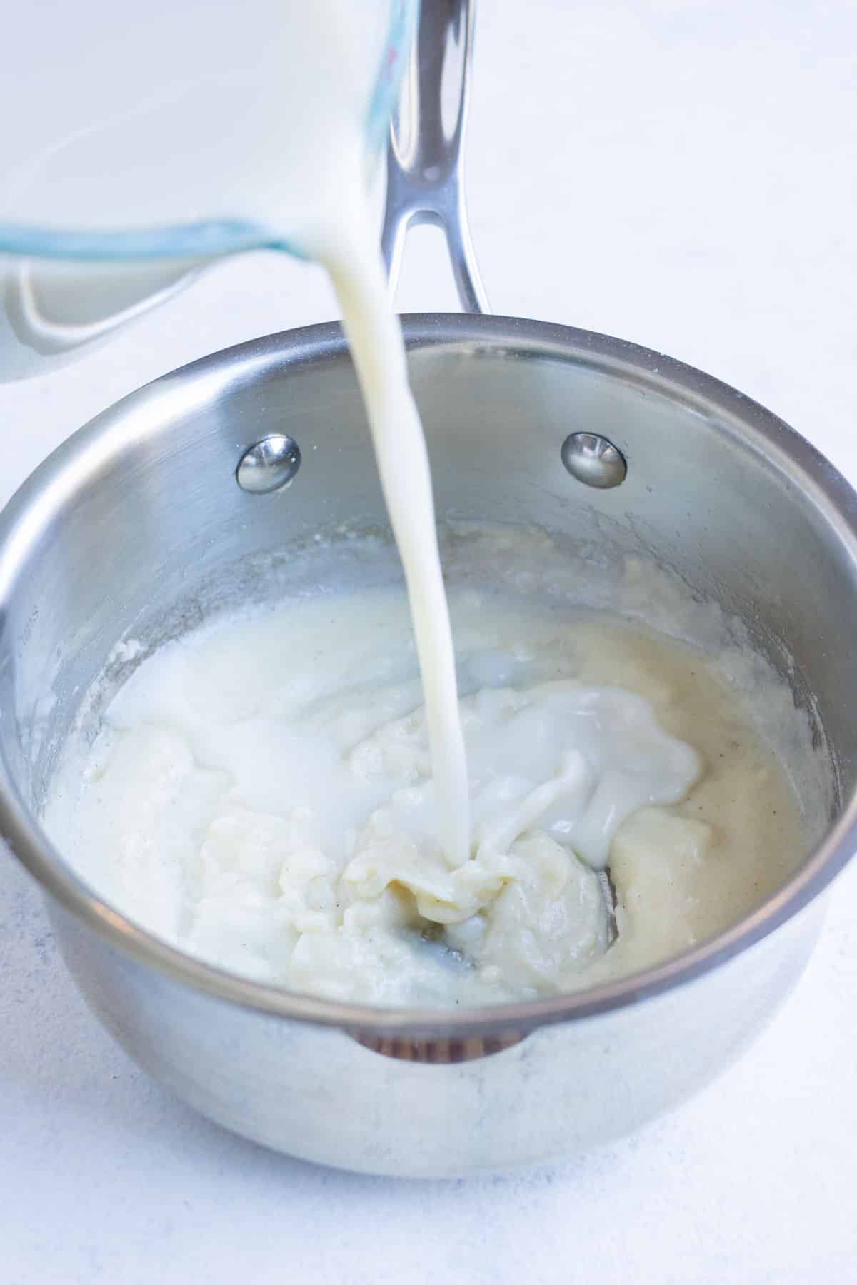 Milk is added to a roux.
