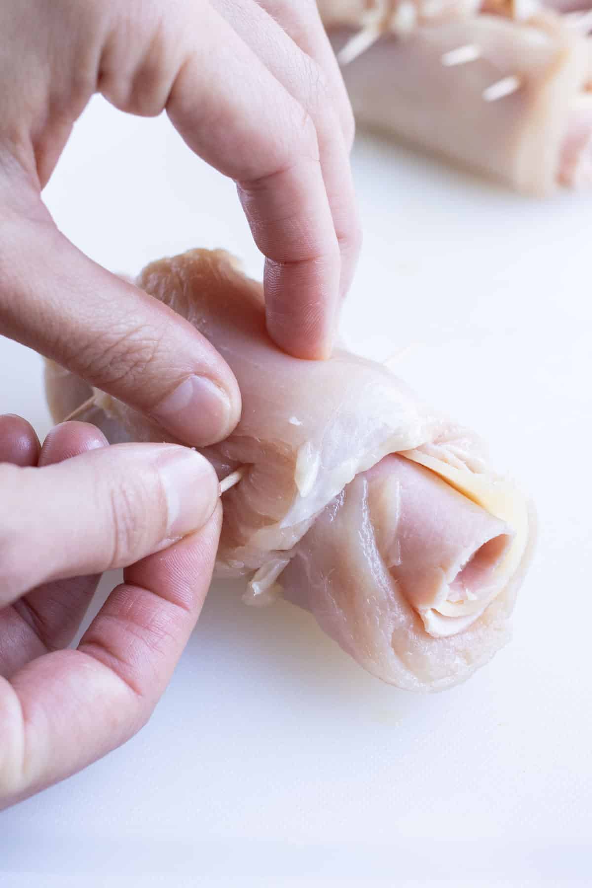 Toothpicks are used to hold the rolled chicken together.