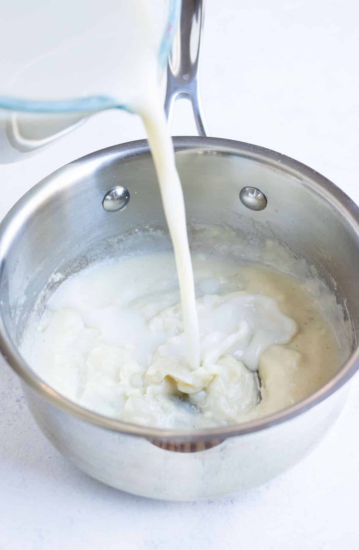 Milk is poured into a saucepan to make a cordon bleu sauce.