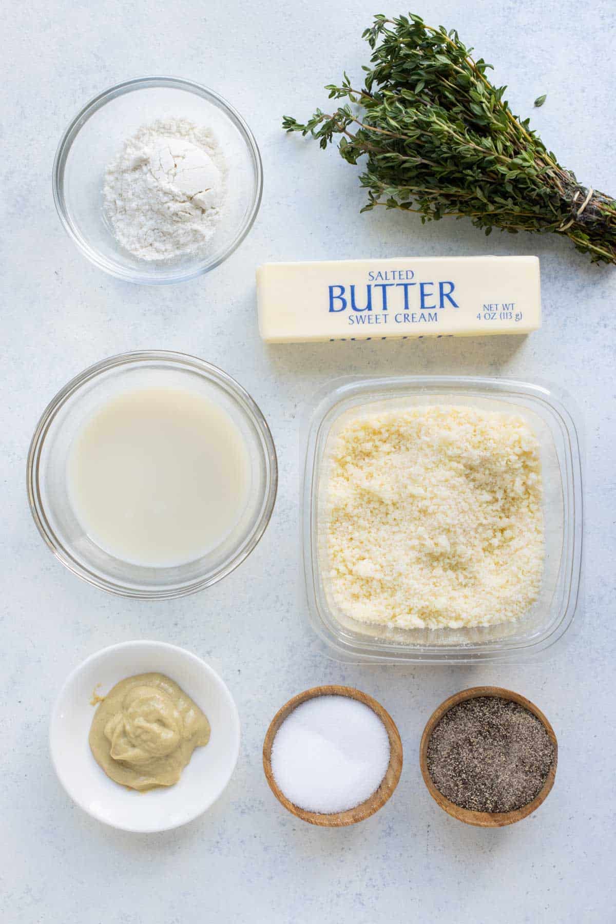 Butter, flour, herbs, mustard, and cheese are the ingredients for the sauce.