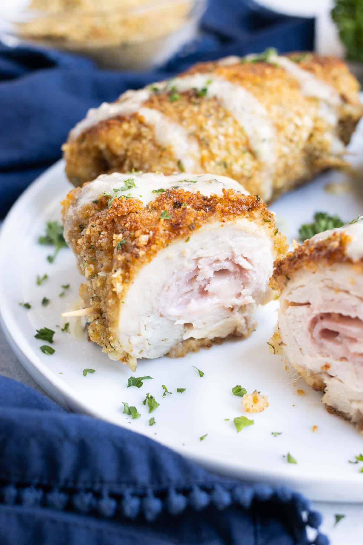 Healthy chicken is rolled with ham and cheese then lightly fried.