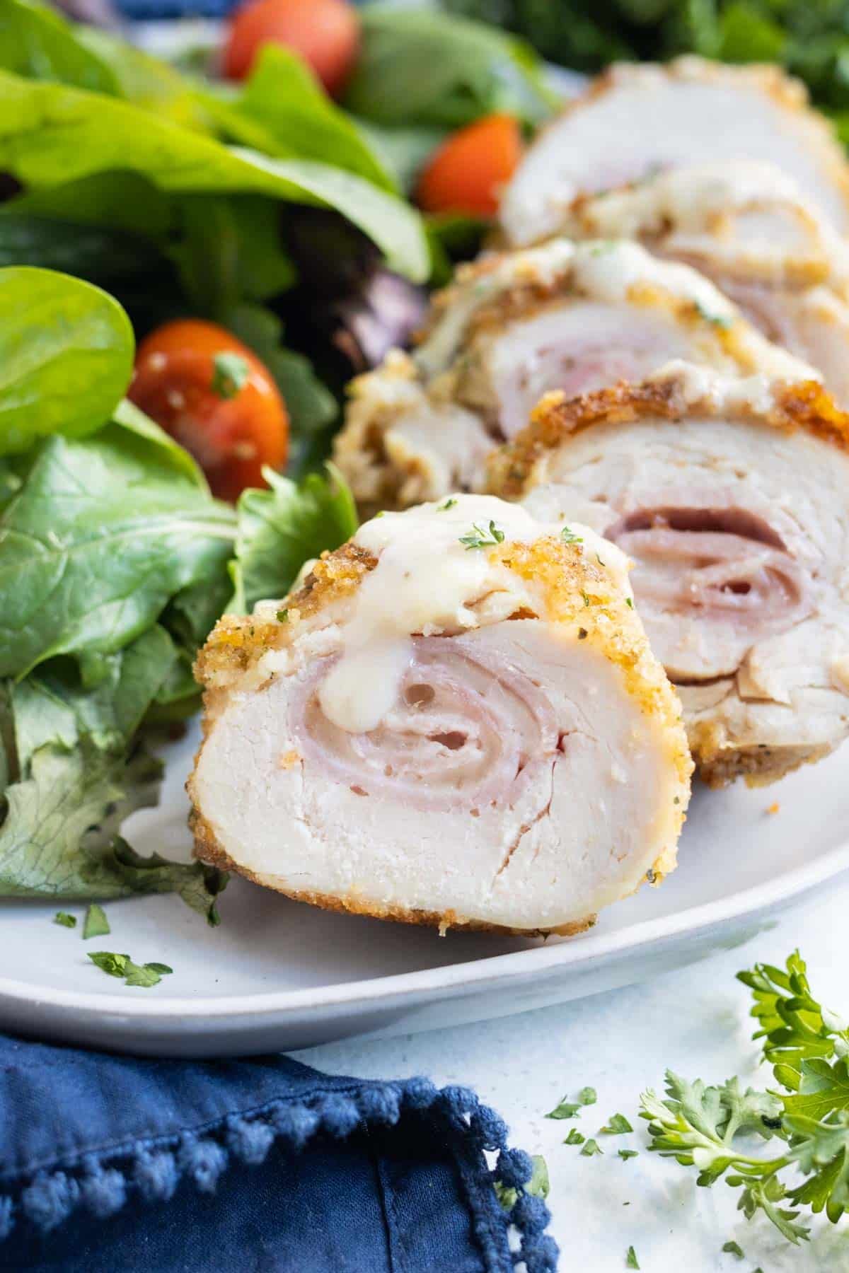 Chicken Cordon Bleu is served with a salad.