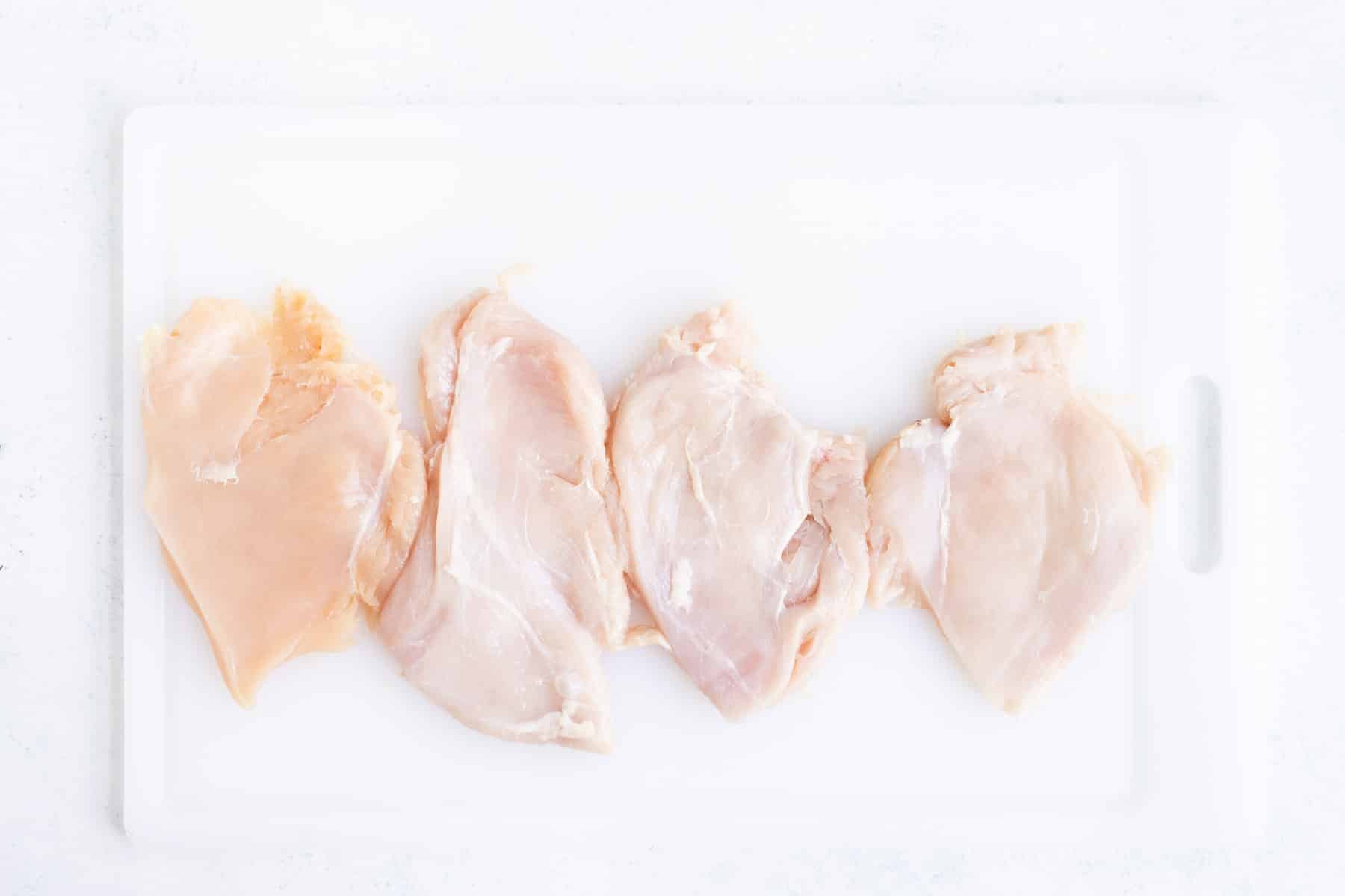 Four pieces of chicken are flattened.