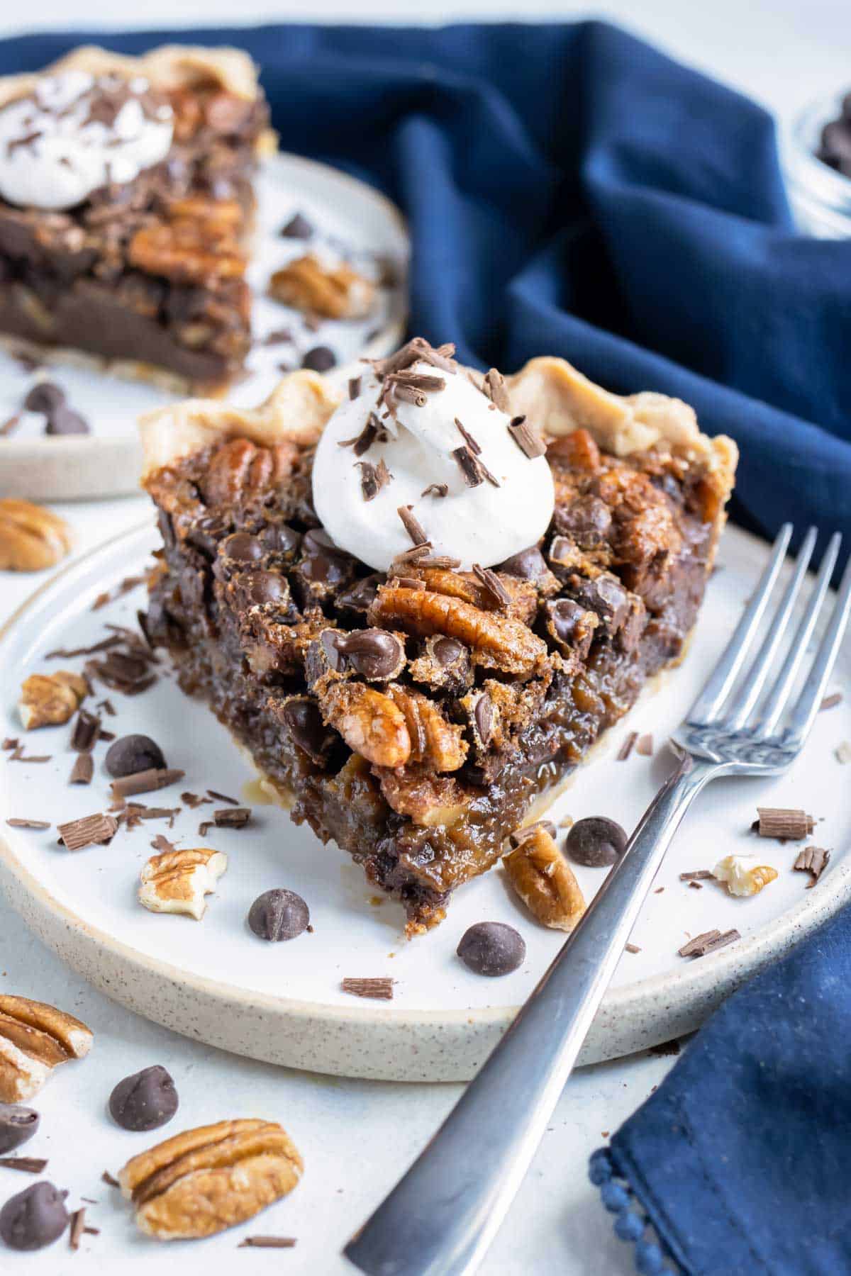 Gluten-free pecan pie is served with a fork on a plate.