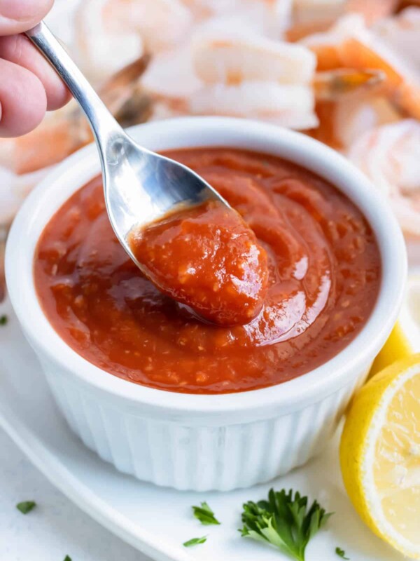 A spoon is used to serve this cocktail sauce appetizer.