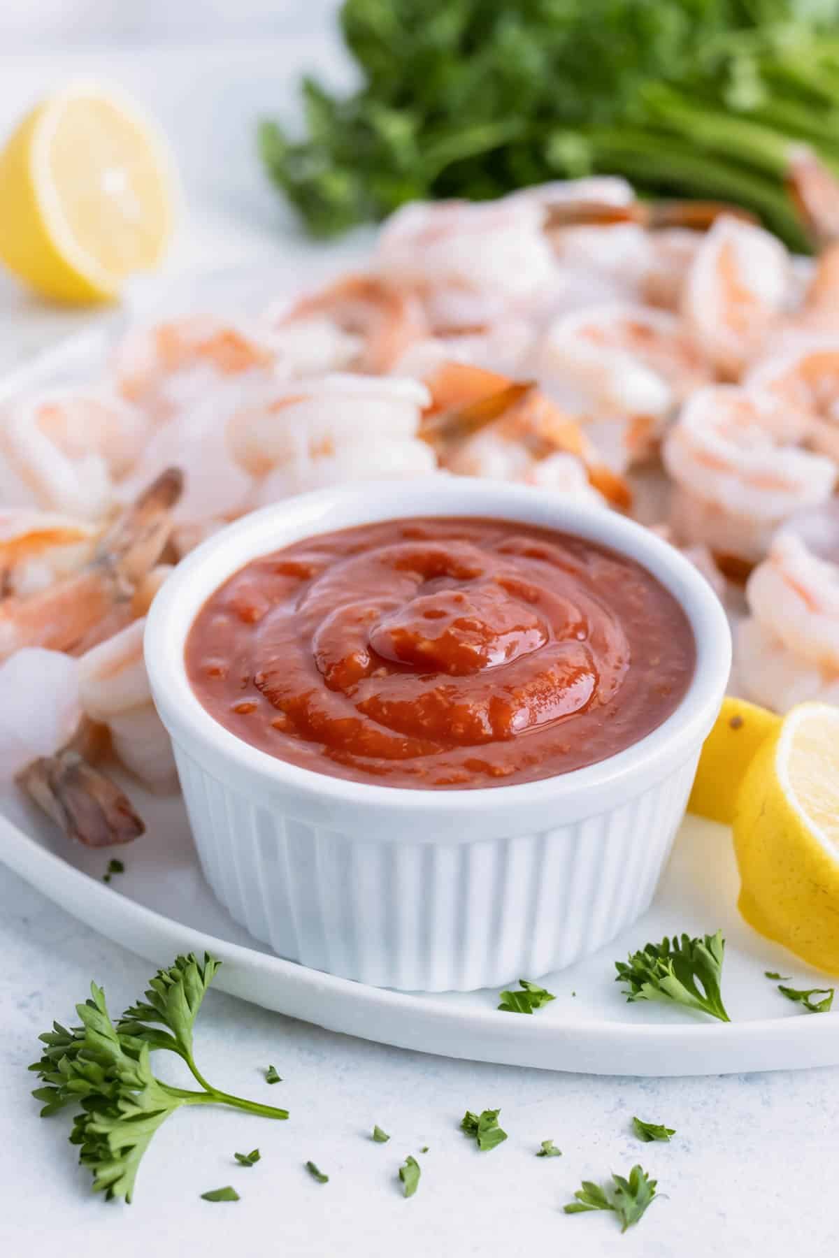 Shrimp is served on a platter with homemade sauce.