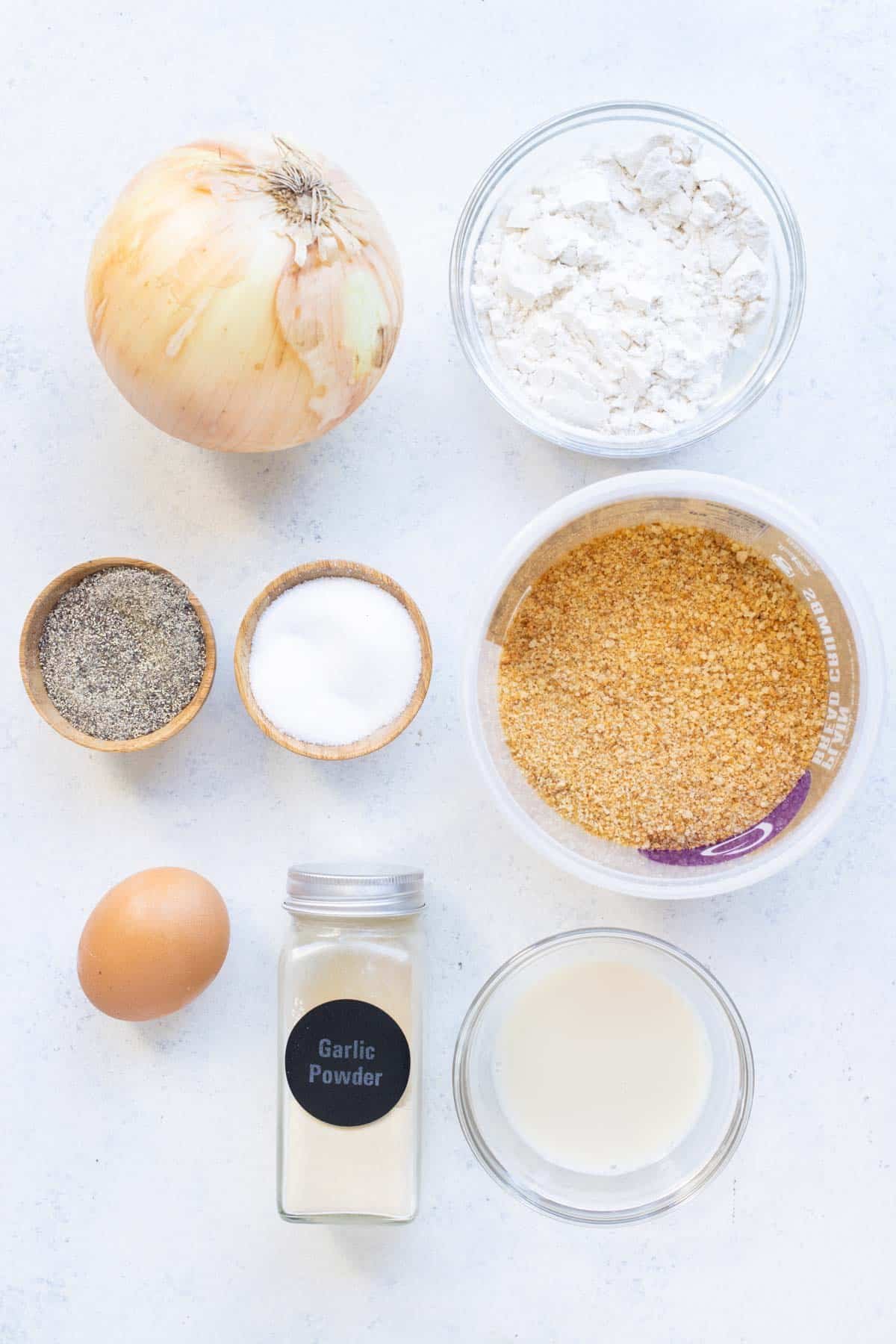 Onion, breadcrumbs, flour, eggs, and seasonings are the ingredients for fried onion strings.