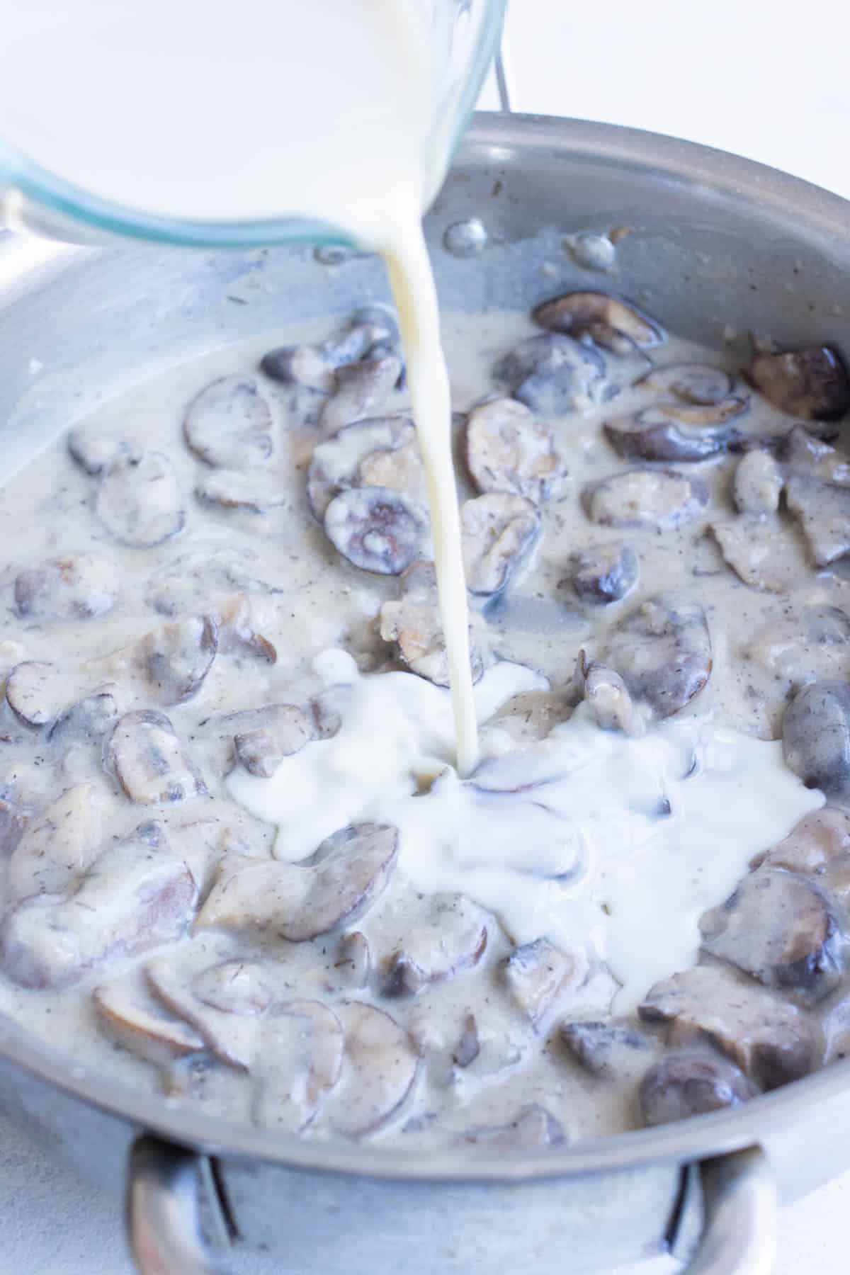 Milk is added to mushrooms and broth.
