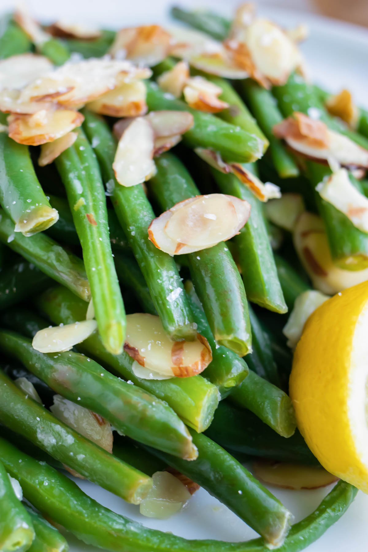 Sliced almonds on top of boiled and blanched green beans with lemon juice.