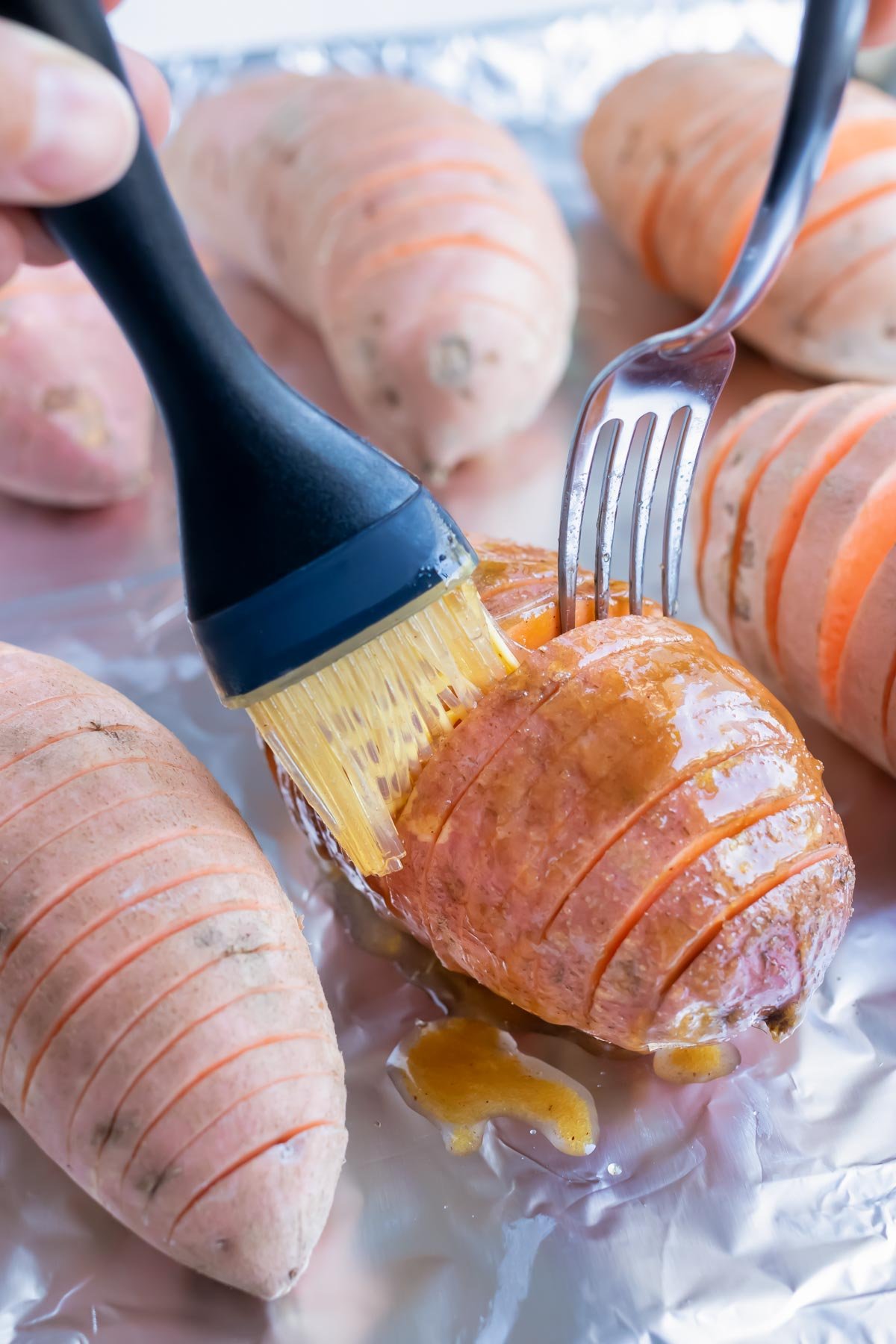 Sweet potatoes are brushed with a melted butter and cinnamon sugar mixture.