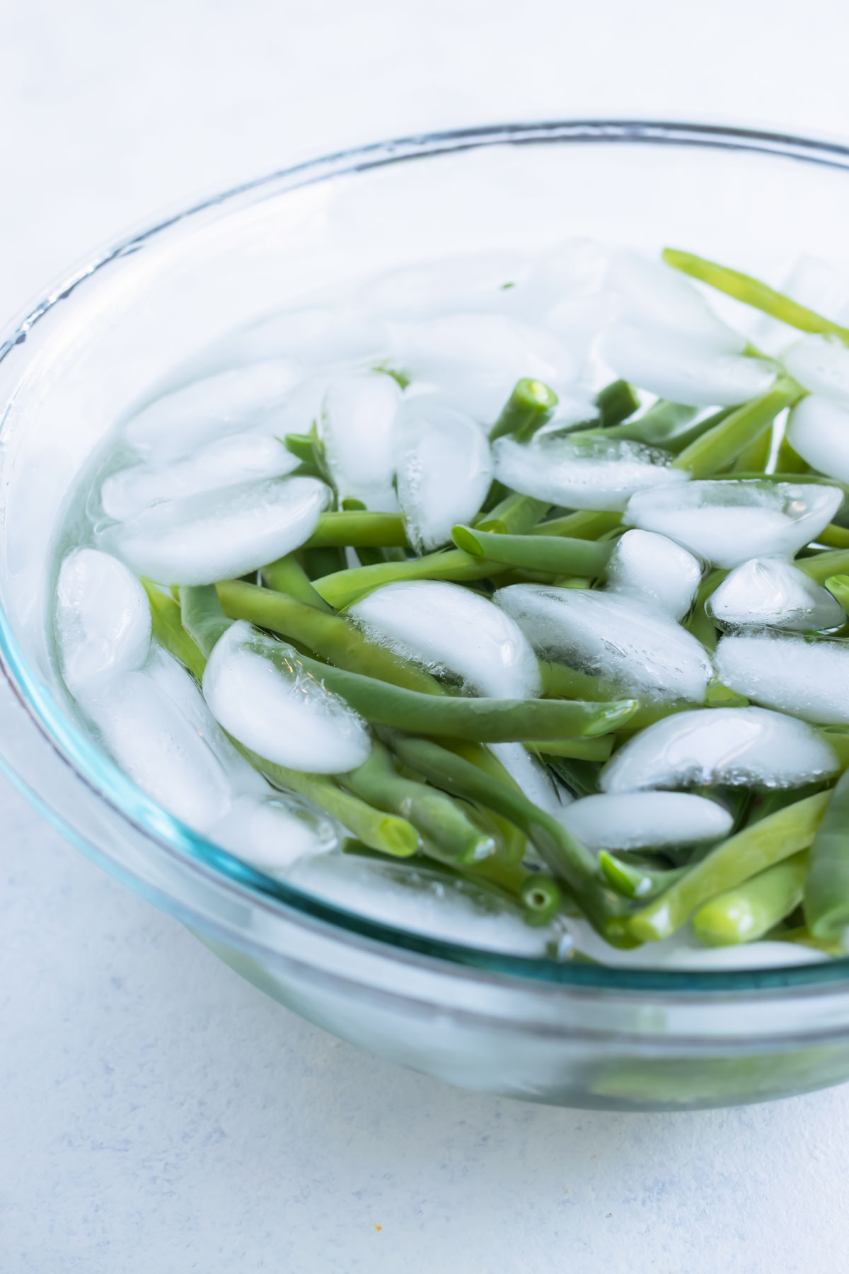 A bowl full of ice and water is used to blanch the beans.