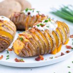 Easy stuffed potato side dish is served with bacon, cheese, sour cream.