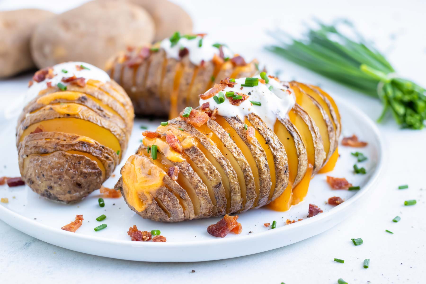 Easy stuffed potato side dish is served with bacon, cheese, sour cream.