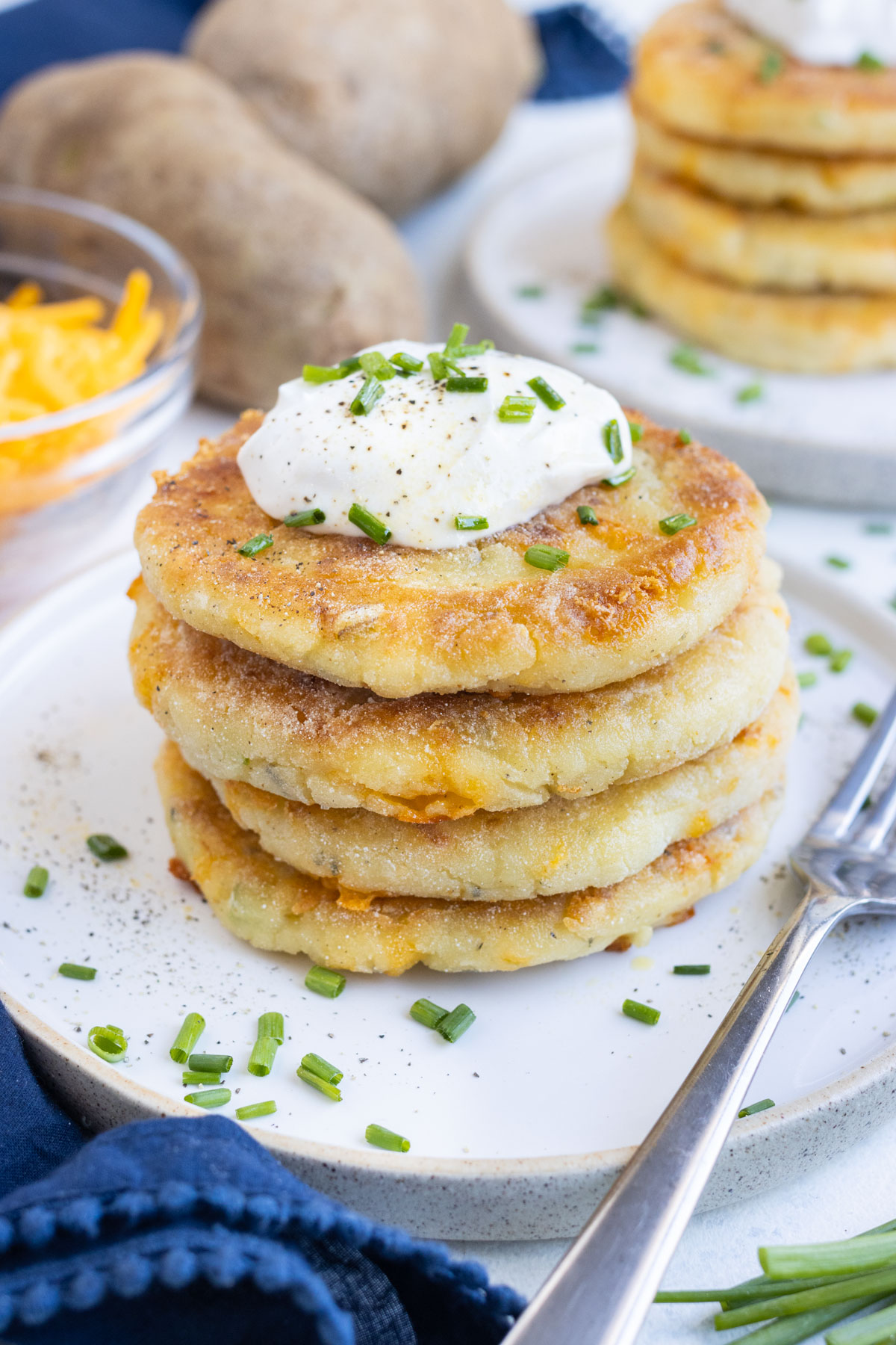 A stack of mashed potato pancakes on a plate.
