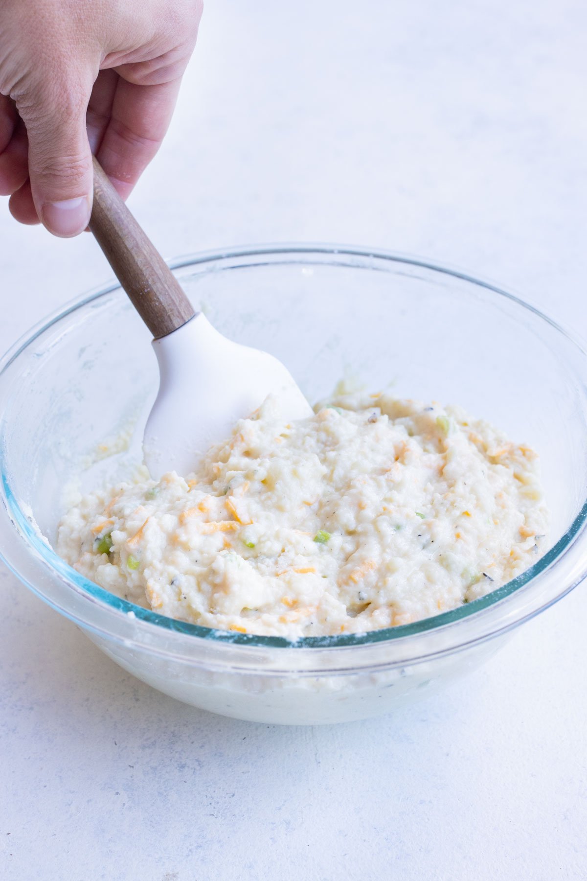 Potato pancake mixture is stirred.