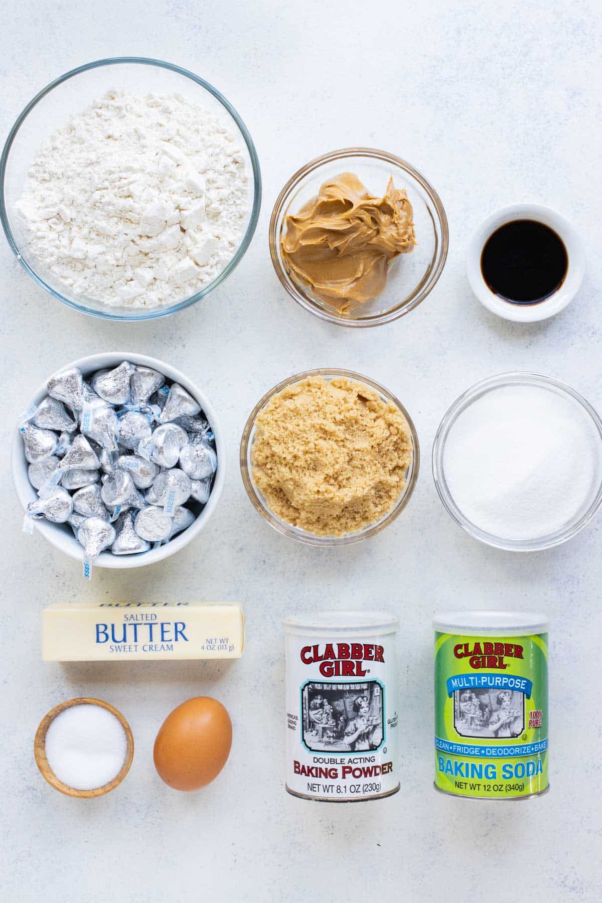 Flour, peanut butter, eggs, sugars, and kisses are the ingredients for these cookies.