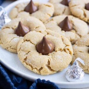 A plate full of sweet and delicious peanut butter cookies with a kiss.