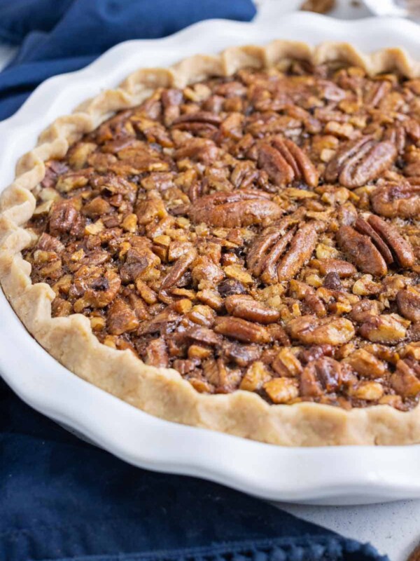A whole pecan pie is shown close up.