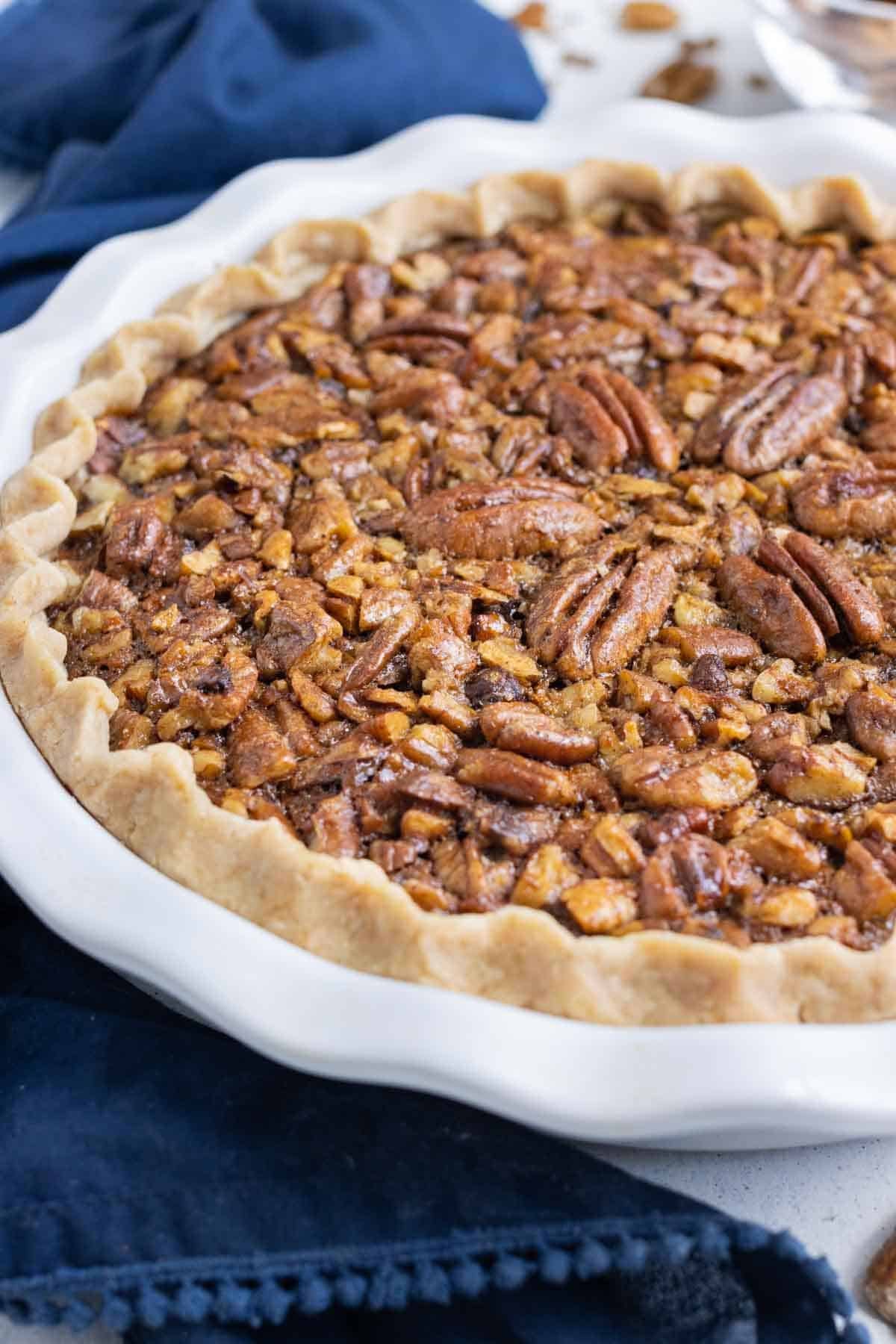 A whole pecan pie is shown close up.