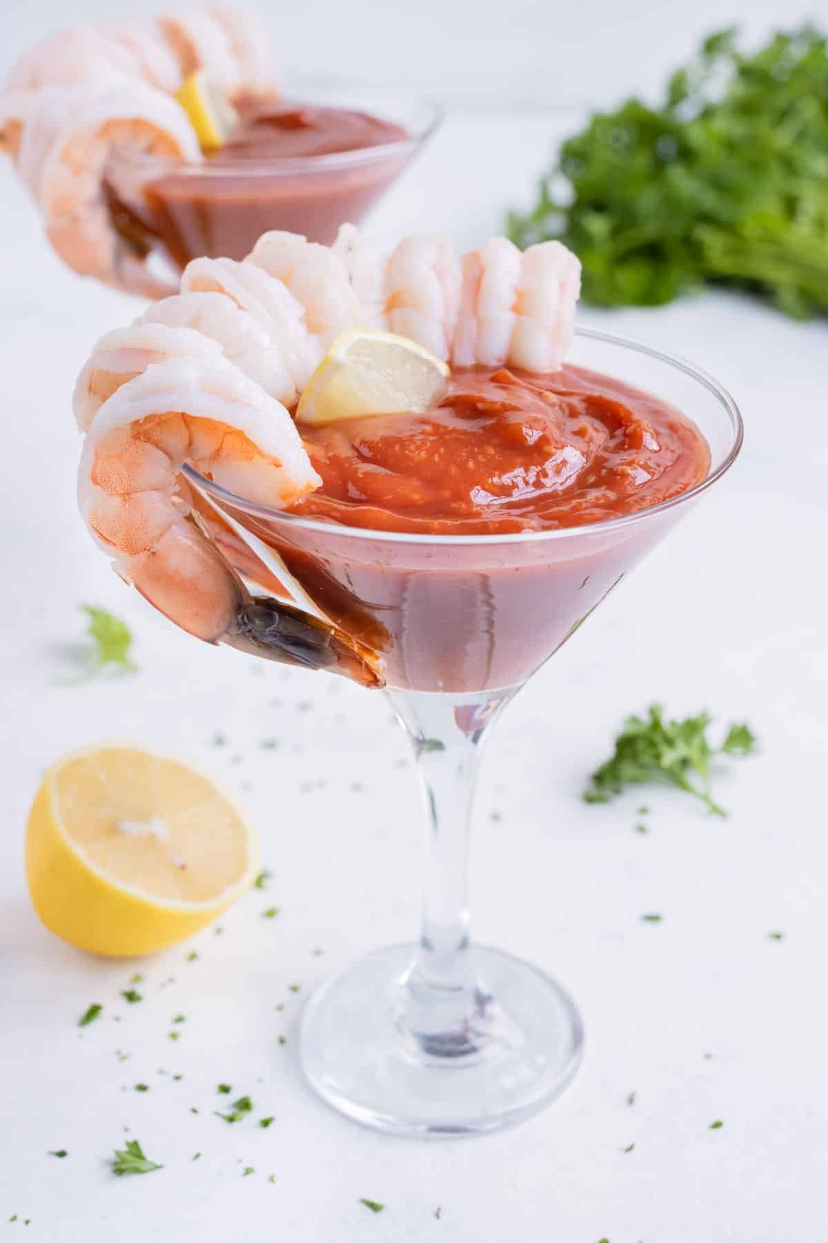 Two glasses of shrimp cocktail are shown on the counter.